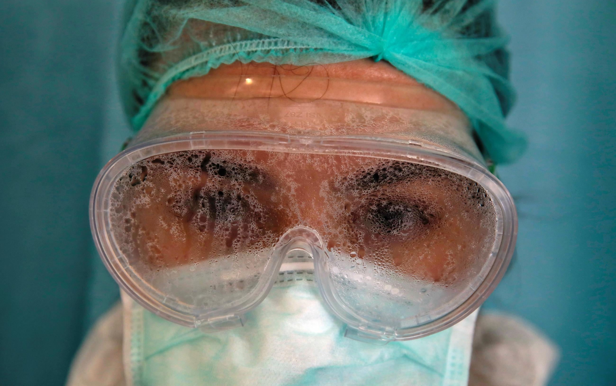 A nurse's goggles are covered with vapor after taking care of a COVID-19 patient during the coronavirus disease (COVID-19) outbreak, at an intensive care unit of the Medicana International Hospital in Istanbul, Turkey, April 14, 2020. 