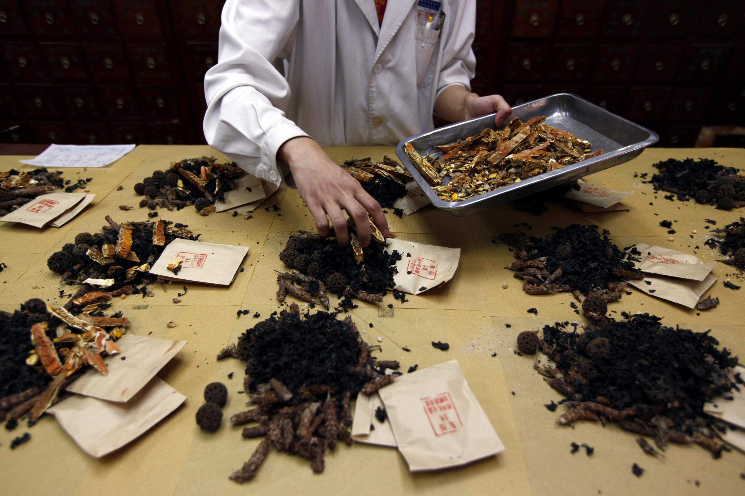 A worker prepares traditional Chinese herbal medicines at Beijing's Capital Medical University Traditional Chinese Medicine Hospital May 25, 2011. The hospital distributes around 20,000 prescription doses daily, more than five tonnes of ingredients, from their stock of 600 different types of plants, herbs, and animal organs. Almost all traditional Chinese herbal medicine has been banned from sale in European Union (EU) countries since May 1, following the implementation of the Traditional Herbal Medicinal P