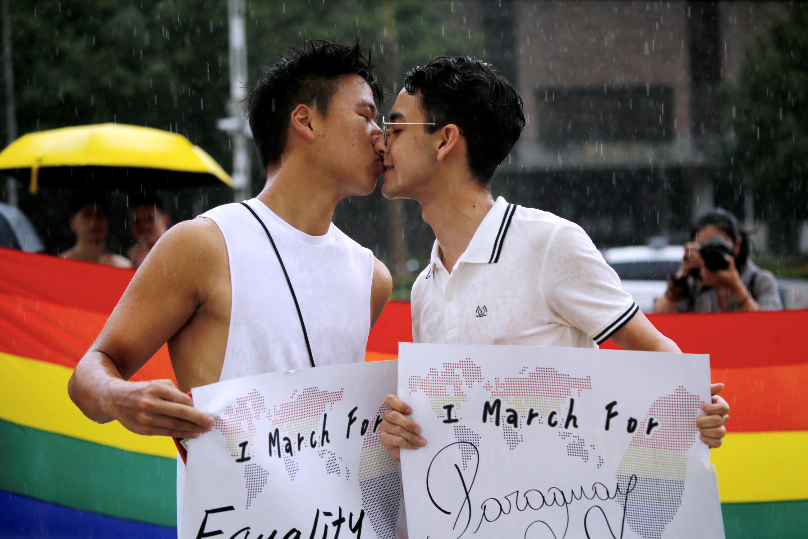 Participants kiss for a photo during the "Taiwan Pride Parade For the World" rally in Taipei, Taiwan, June 28, 2020.