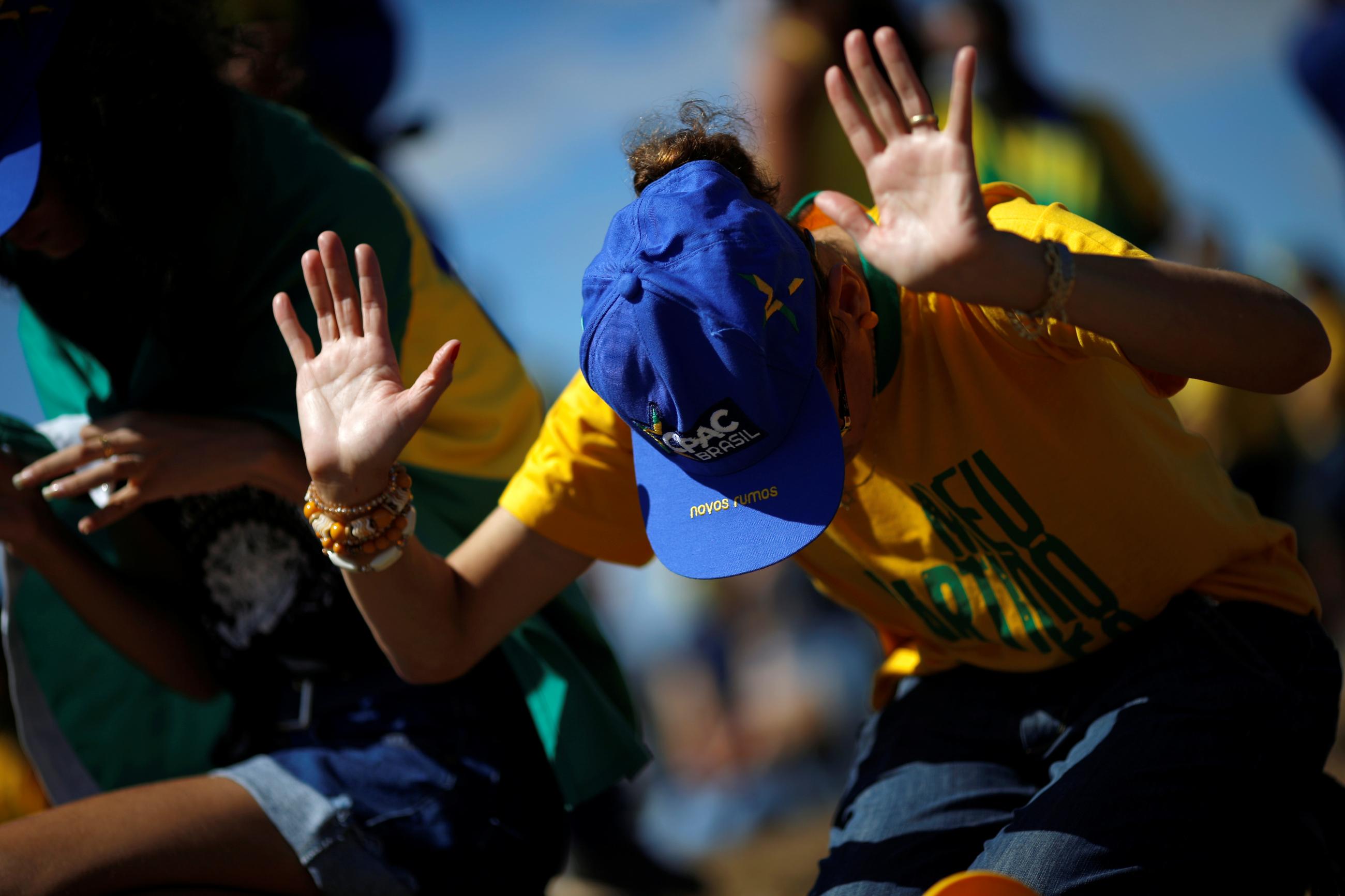 A demonstrator prays during a protest in support of Brazilian President Jair Bolsonaro, amid the coronavirus disease outbreak, in Brasilia, Brazil on July 19, 2020. 