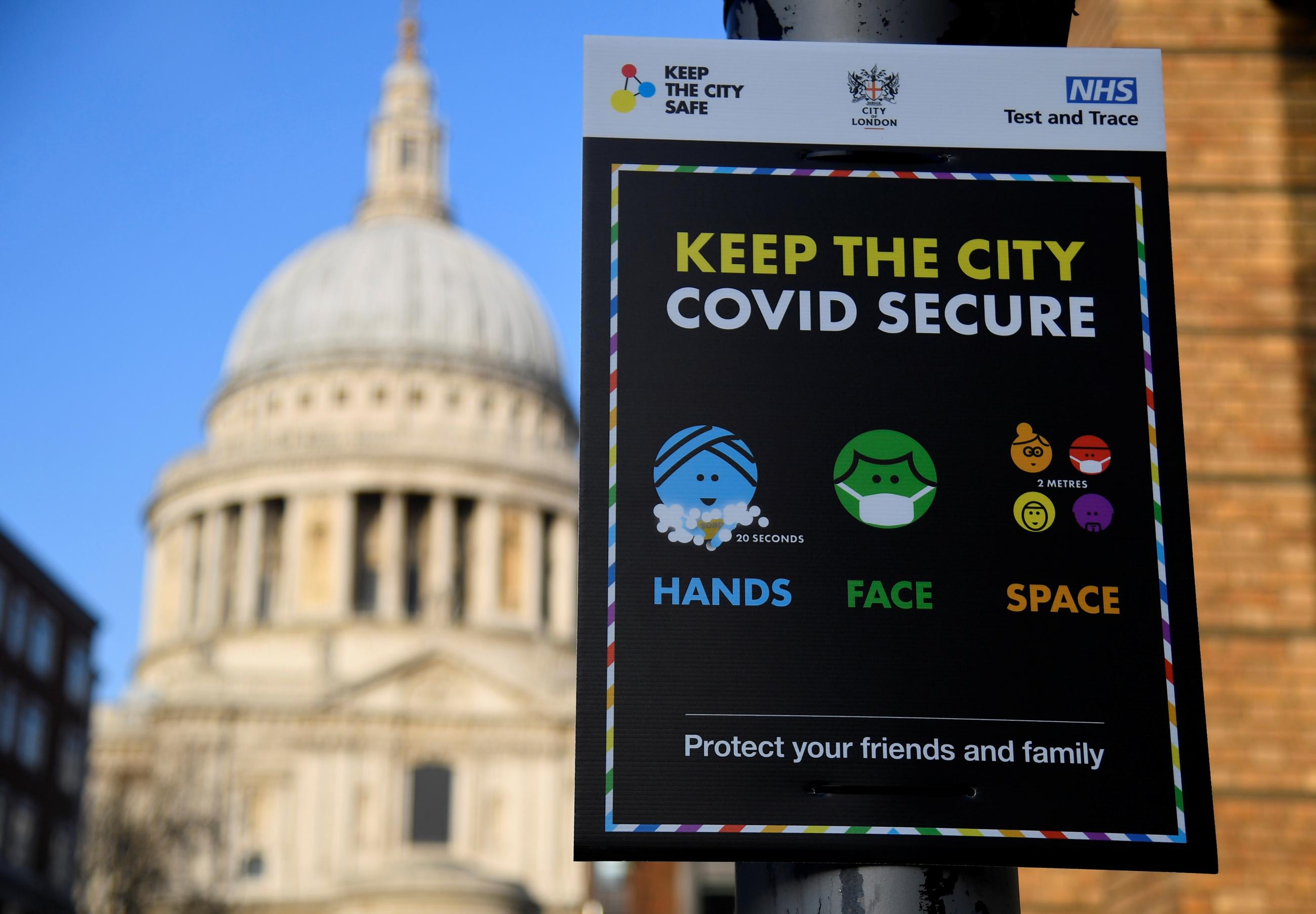 A public health information sign is seen with St. Paul's Cathedral seen behind amidst a lockdown during the spread of the coronavirus disease pandemic, London, Britain, January 7, 2021.