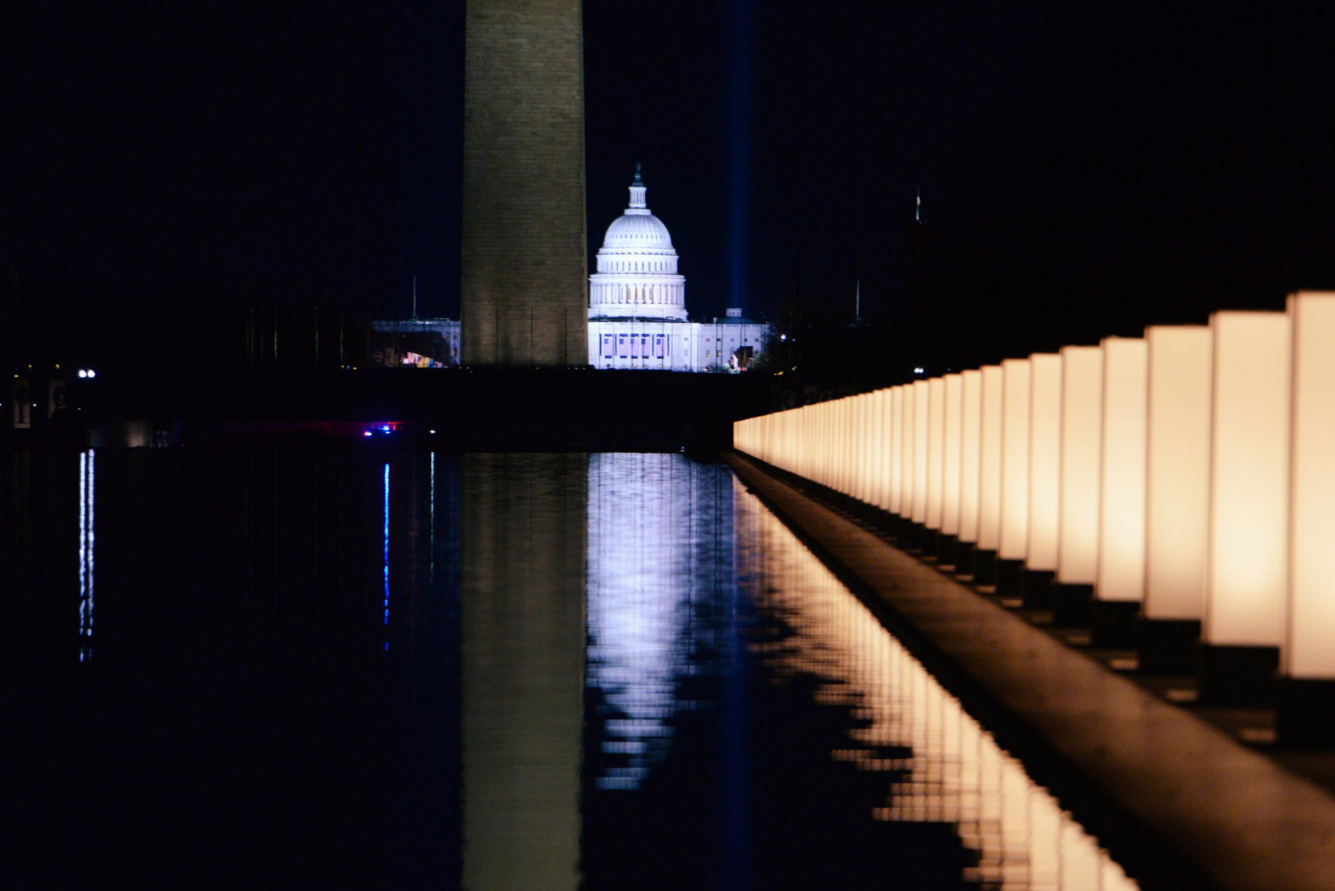 The U.S. Capitol Building is seen reflected after President Joe Biden hosts a memorial to honor those who died from coronavirus disease in Washington, DC on January 19, 2021.
