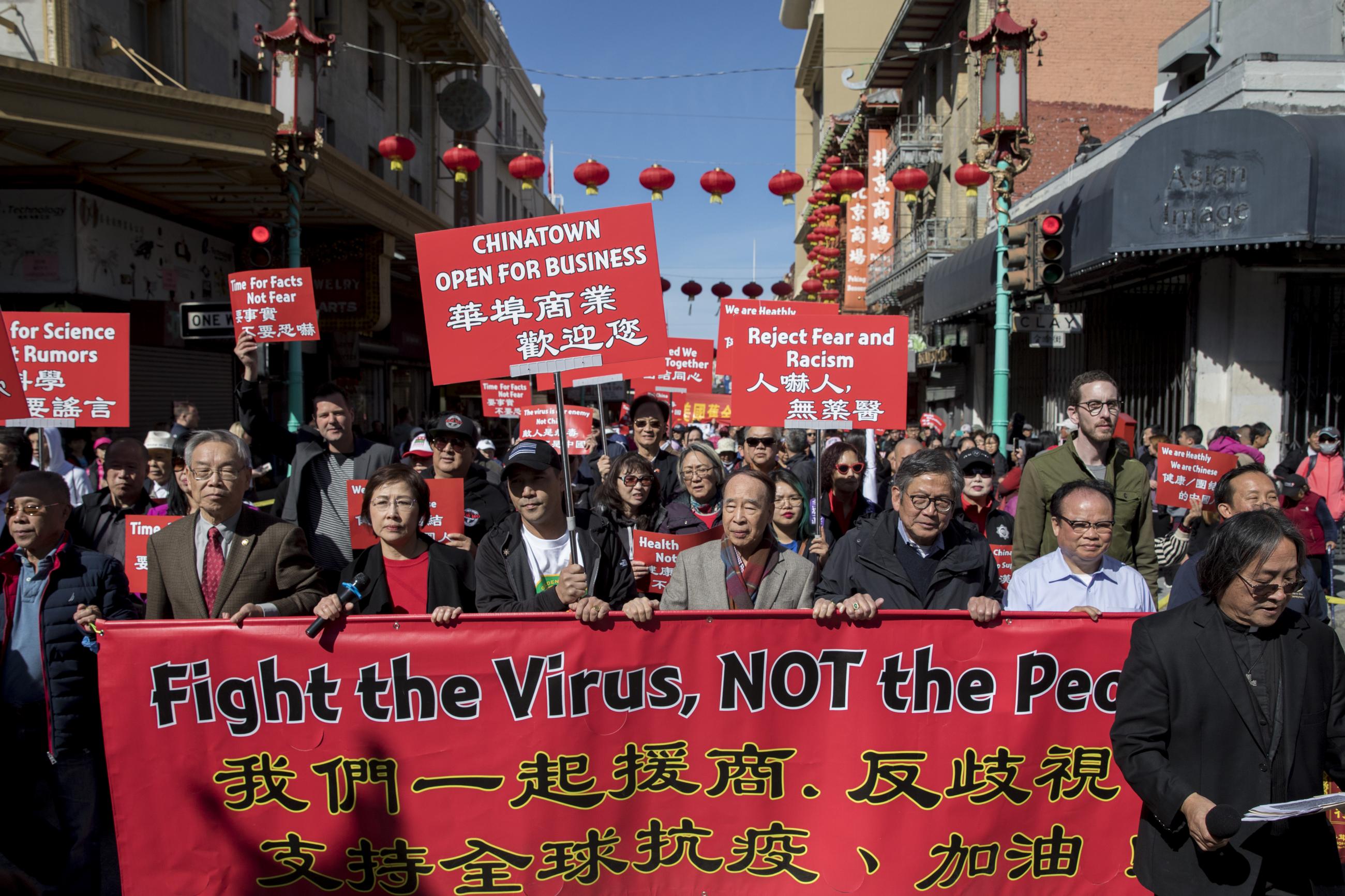 Hundreds of Chinatown residents along with local and state officials take to the streets protest against racism against the Chinese community during a march down Grant Avenue from Chinatown's Portsmouth Square to Union Square in San Francisco, Calif. Saturday, February 29, 2020.