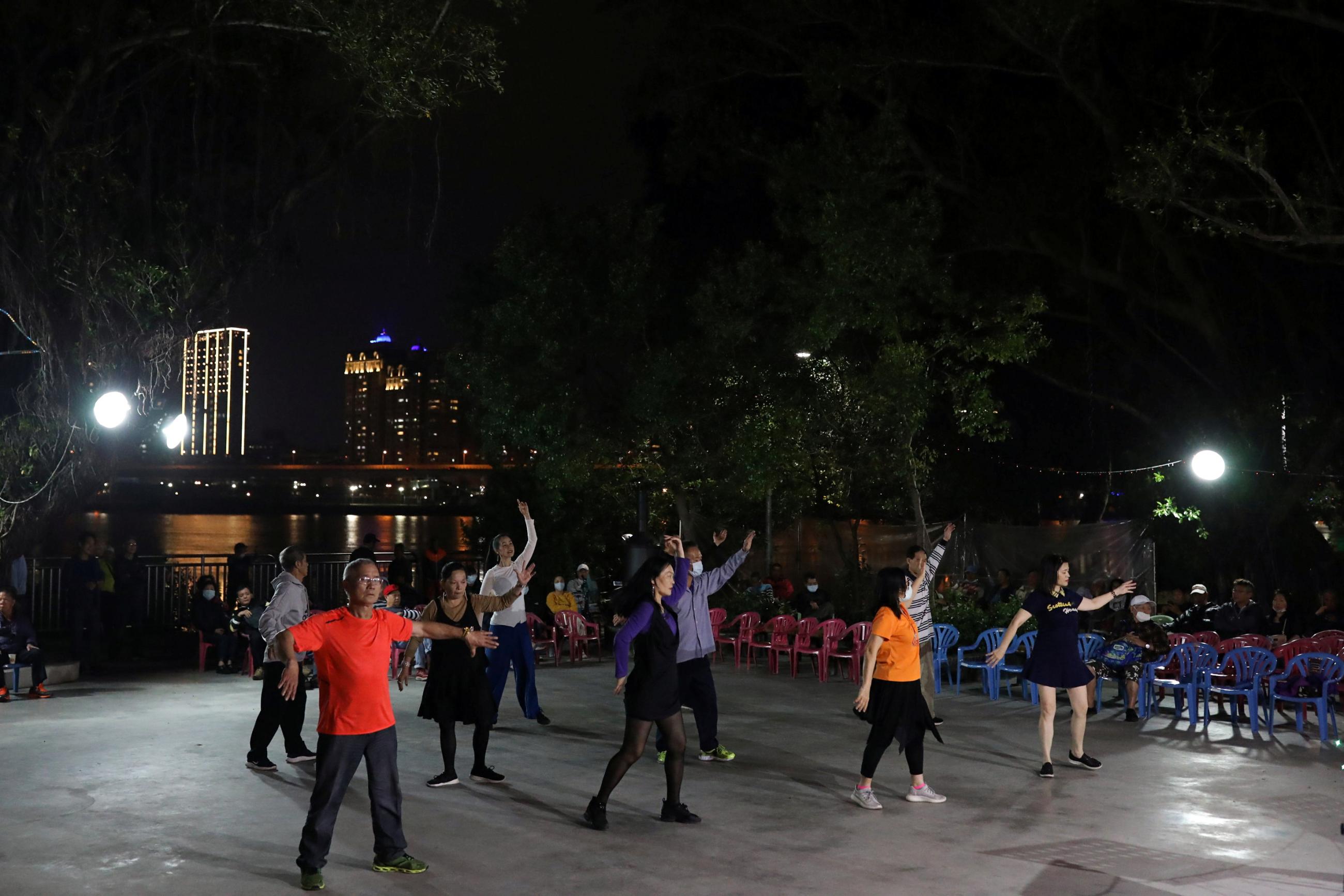 People dance to the music at a temple in Taipei, Taiwan on March 24, 2020. 