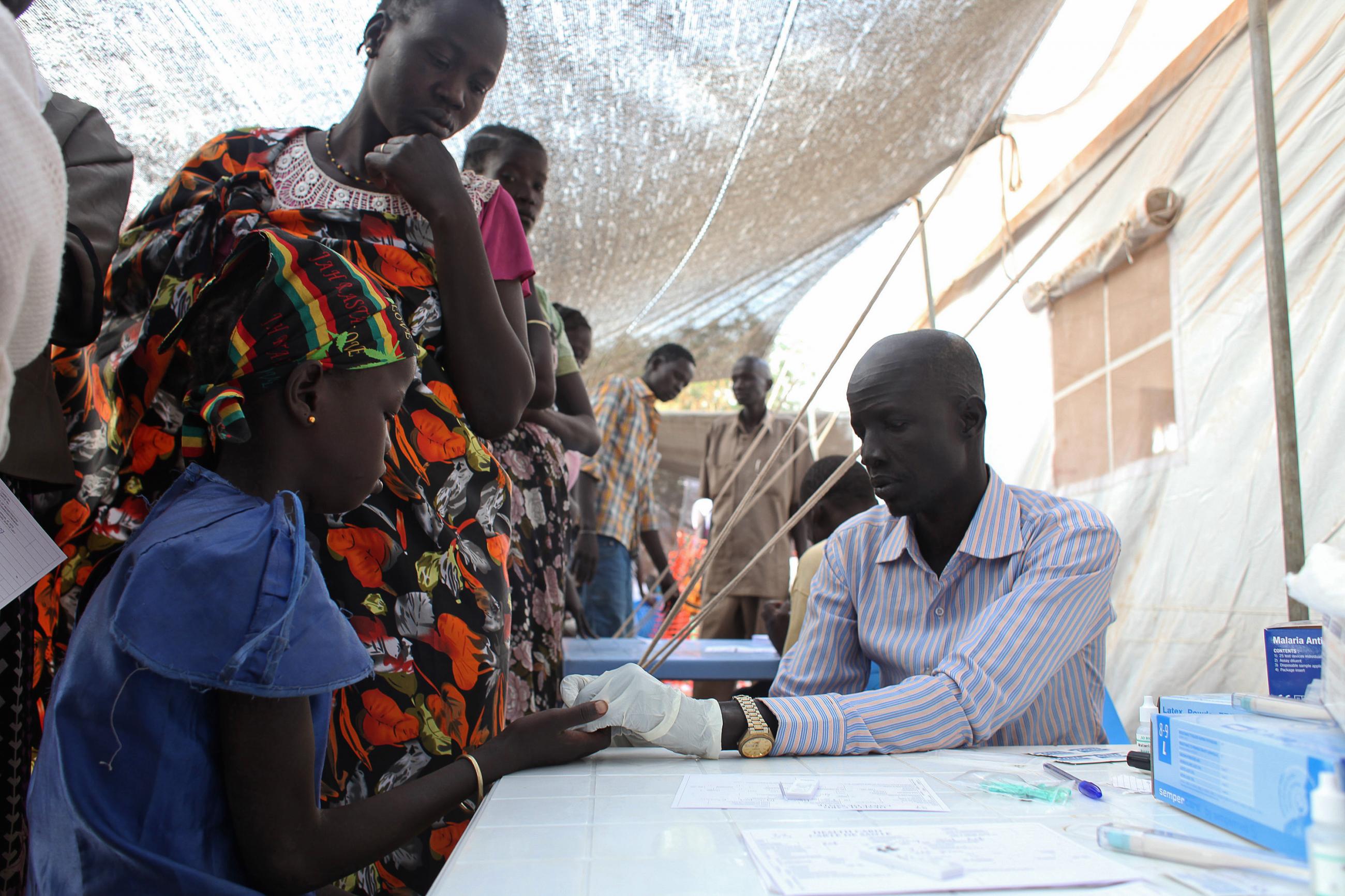 A displaced girl is tested for malaria at an MSF clinic in Tomping camp, Juba, South Sudan on January 10, 2014.