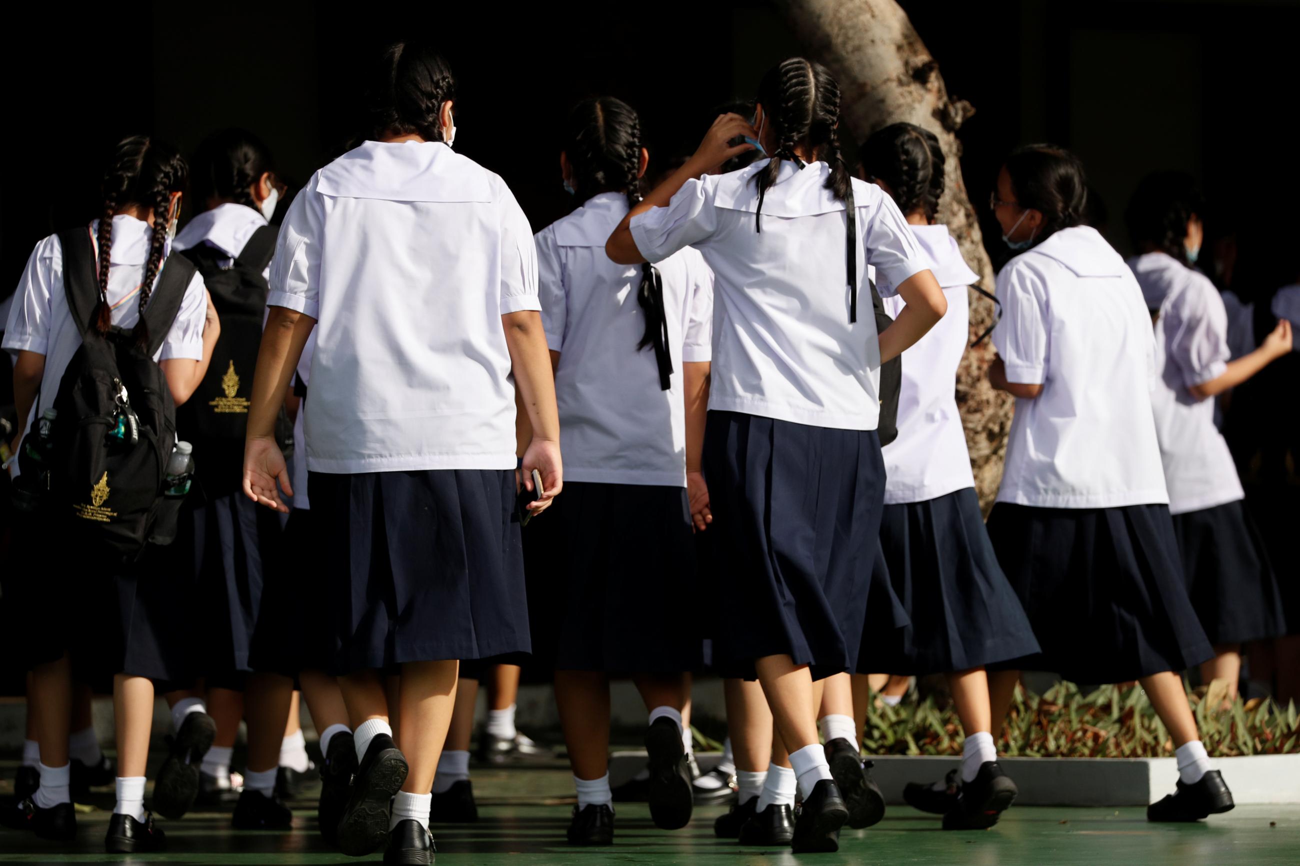 Girls walk to a school wearing mandatory uniforms in Bangkok, Thailand September 15, 2020.