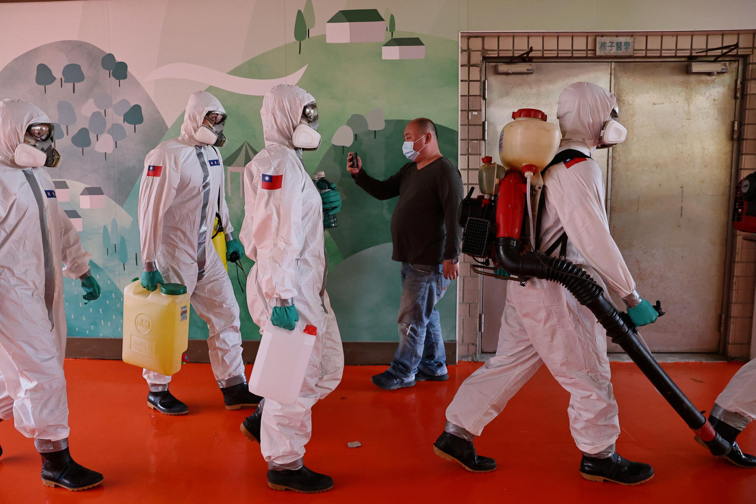 Soldiers prepare to spray disinfectant at the Taoyuan General Hospital, where a cluster of coronavirus disease (COVID-19) infections was detected, in Taoyuan, Taiwan, January 19, 2021.