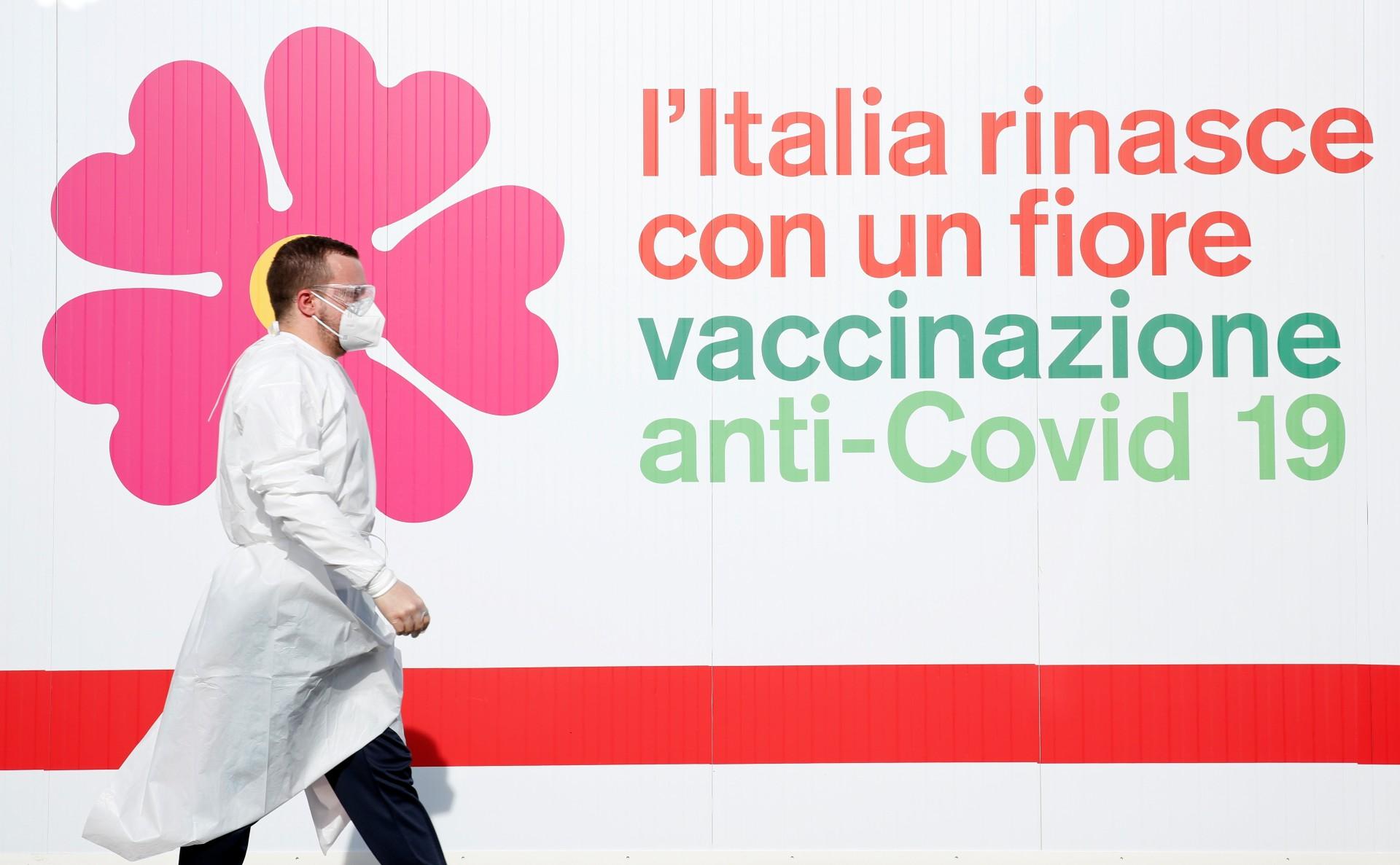 A man walks outside a tent during preparations to turn the long-term car park at Fiumicino airport into a coronavirus disease vaccination center in Rome, Italy on February 5, 2021.