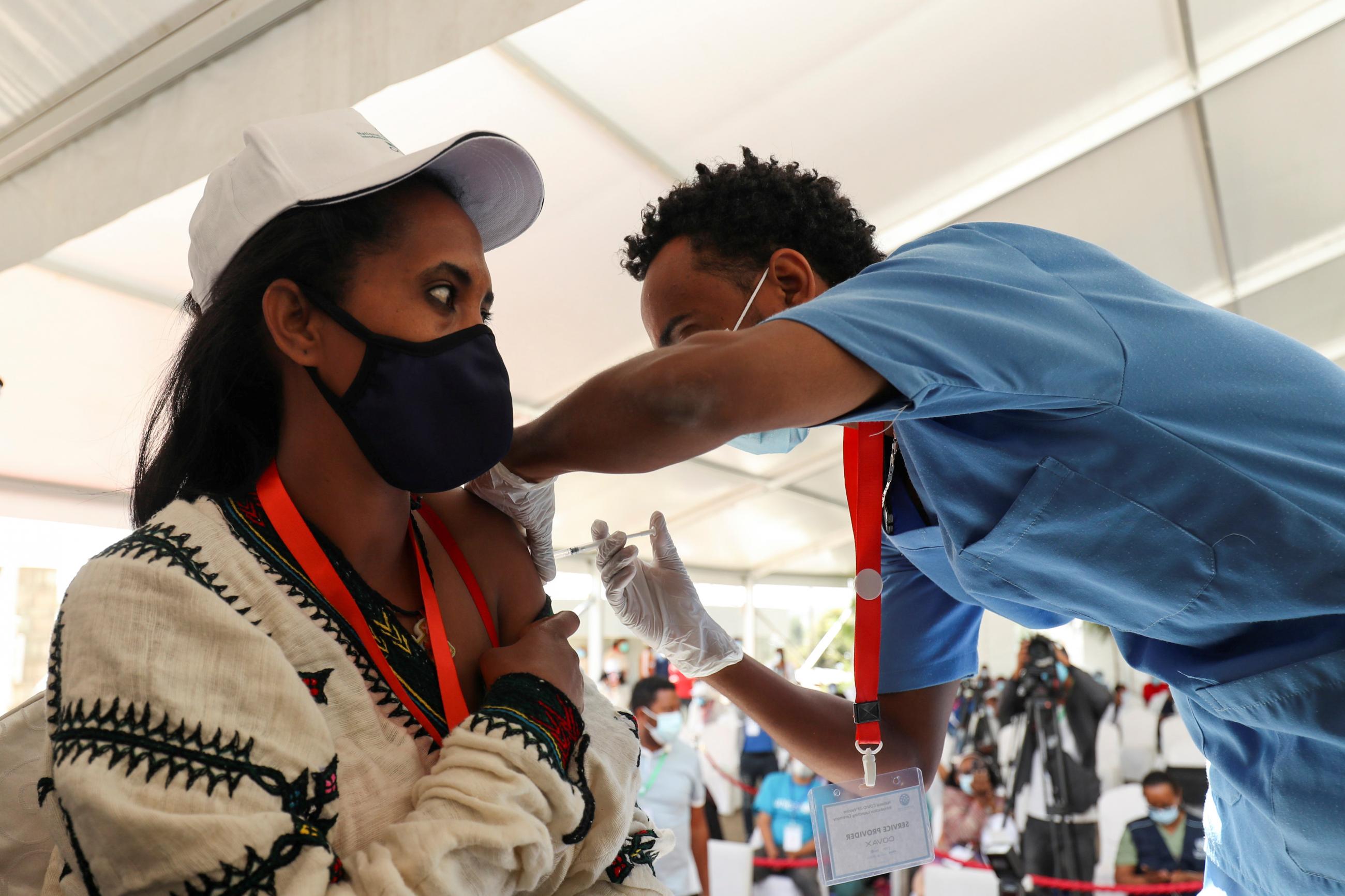 A woman receives the AstraZeneca/Oxford vaccine under the COVAX scheme against the coronavirus disease at the Eka Kotebe General Hospital in Addis Ababa, Ethiopia on March 13, 2021.