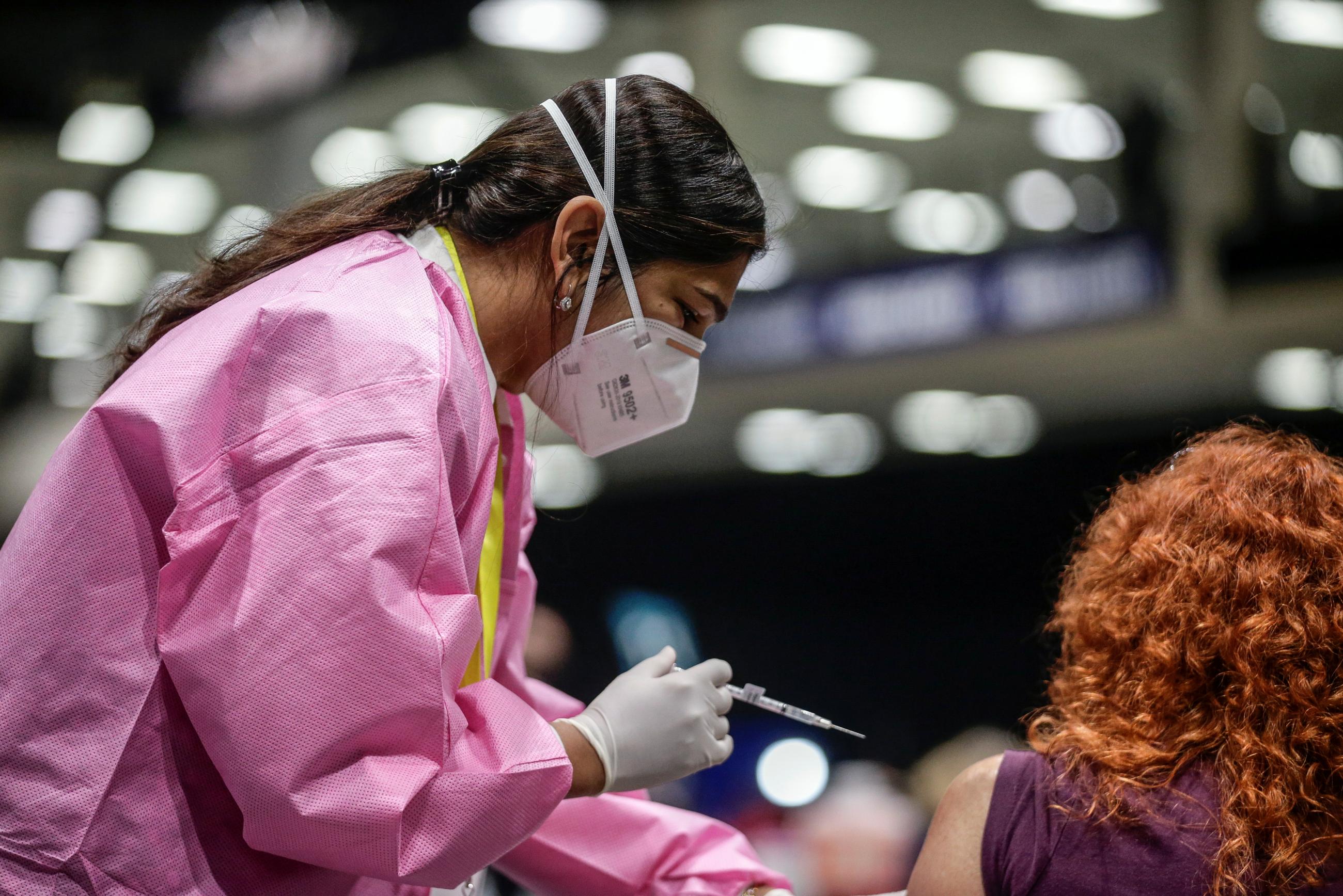 A health-care worker administers a coronavirus disease (COVID-19) vaccine at a mass vaccination site at Lumen Field Event Center in Seattle, Washington on March 13, 2021.