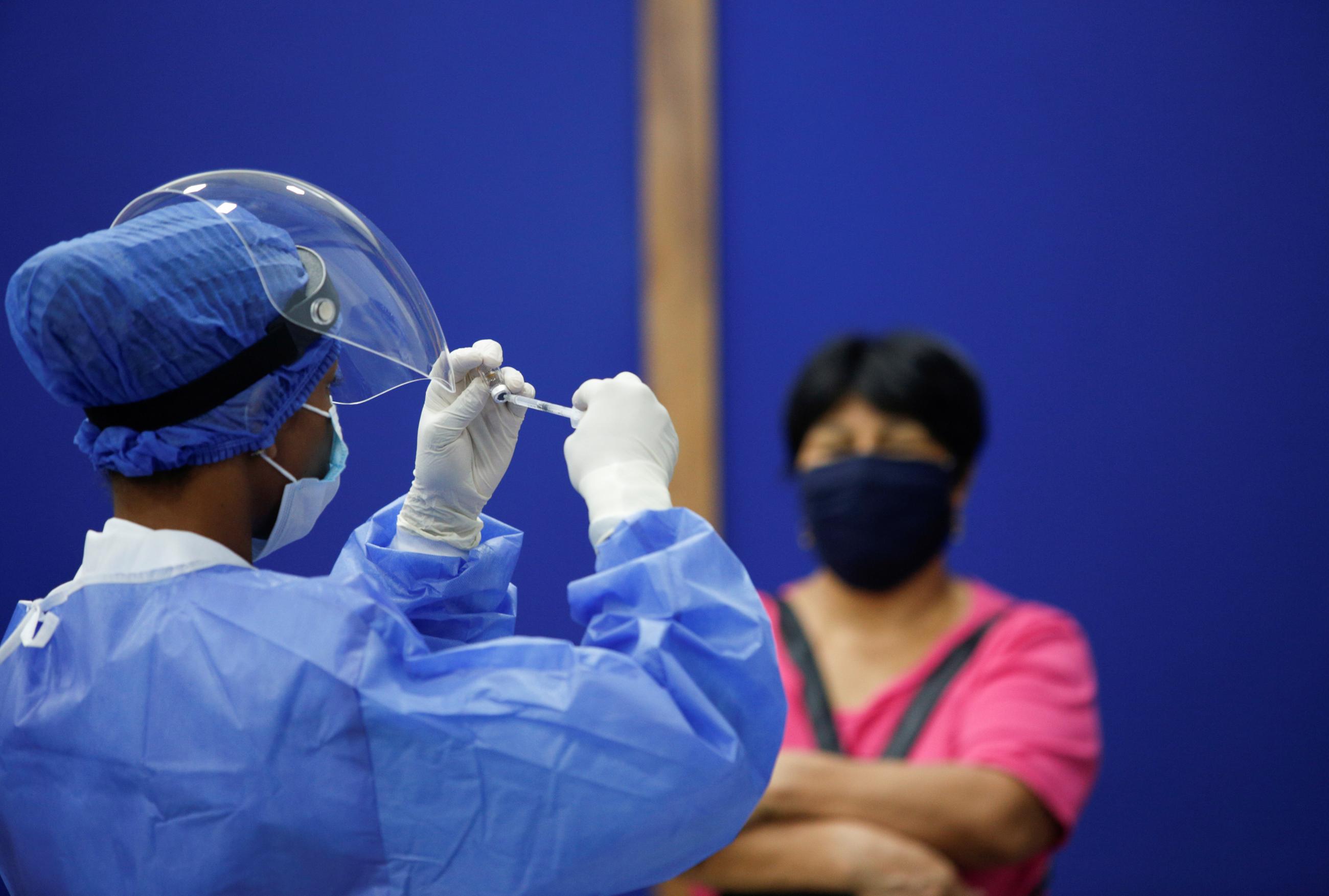 A nurse prepares a dose of China's Sinovac Biotech vaccine during a mass vaccination program for the elderly, at the Bolivarian Technology Institute in Guayaquil, Ecuador on April 15, 2021.