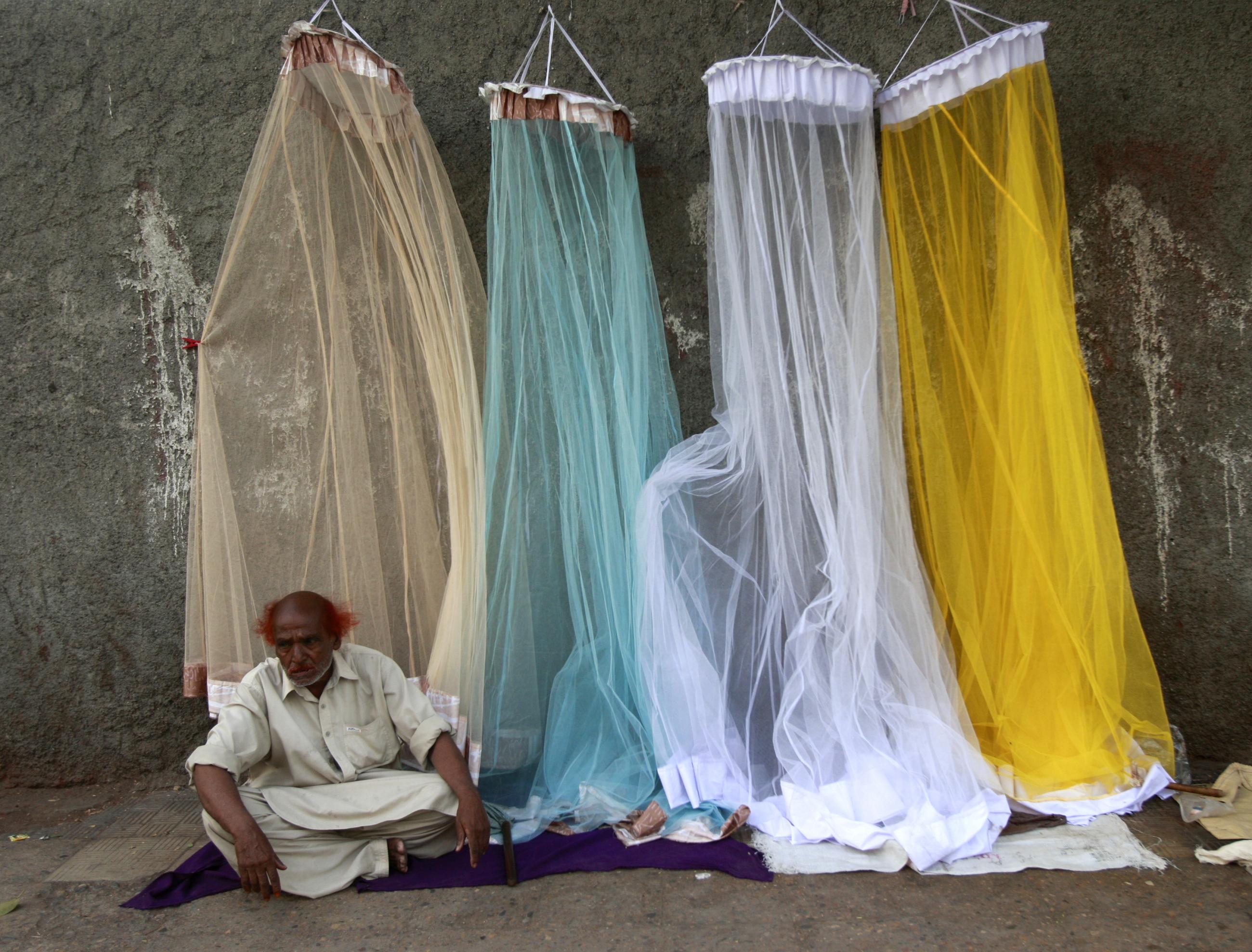 A man sells mosquito nets for 300 PKR (about $4 USD) street-side in Karachi, Pakistan on May 19, 2009.