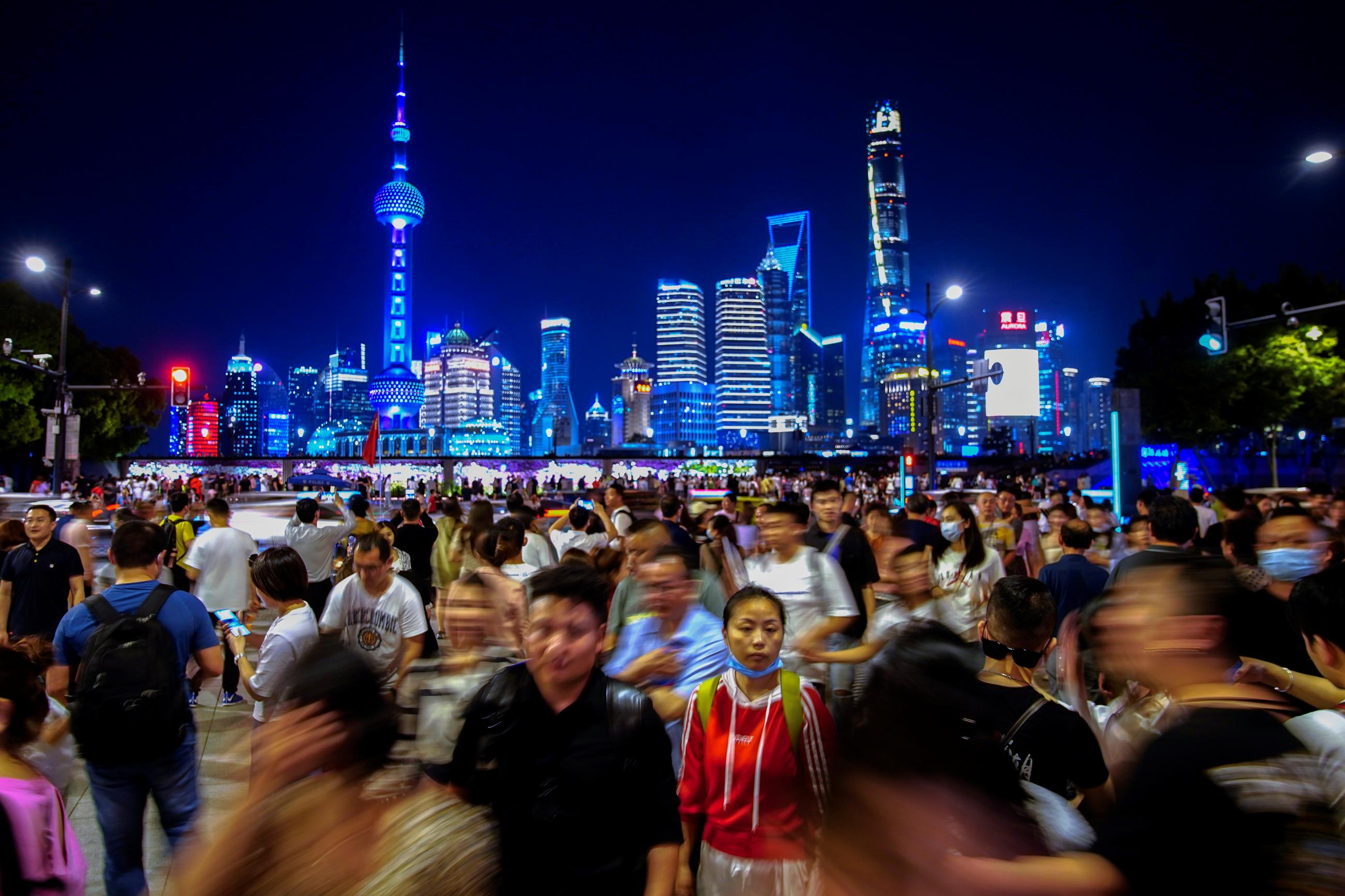 People walk along near the Bund, in front of Lujiazui financial district of Pudong, following the outbreak of the coronavirus disease (COVID-19), in Shanghai, China May 10, 2021