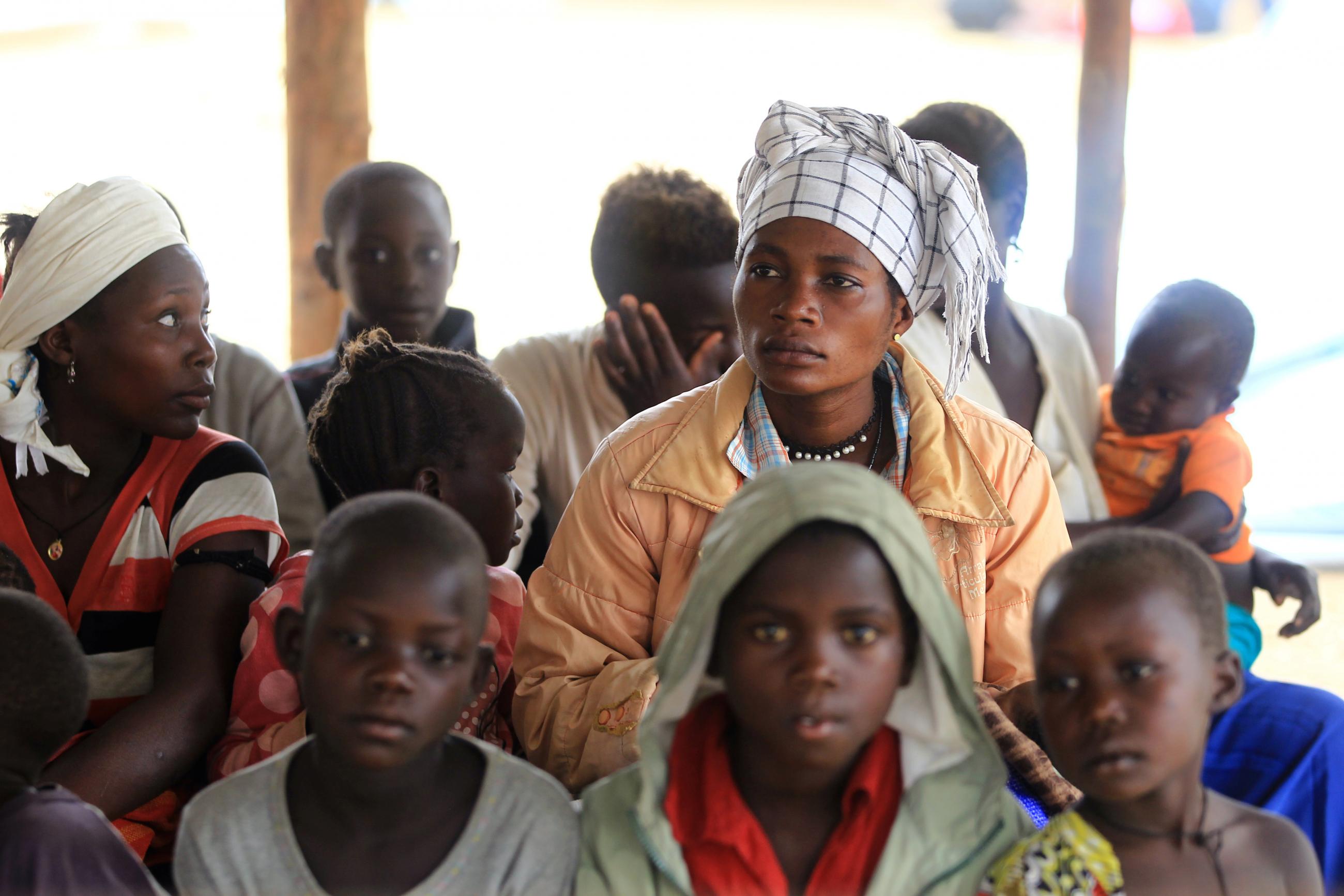 A Congolese family, who migrated from Democratic Republic of Congo by fleeing on a boat across Lake Albert, waits to be registered by United Nations High Commission for Refugees (UNHCR) in Ntoroko, Uganda February 17, 2018. REUTERS/James Akena