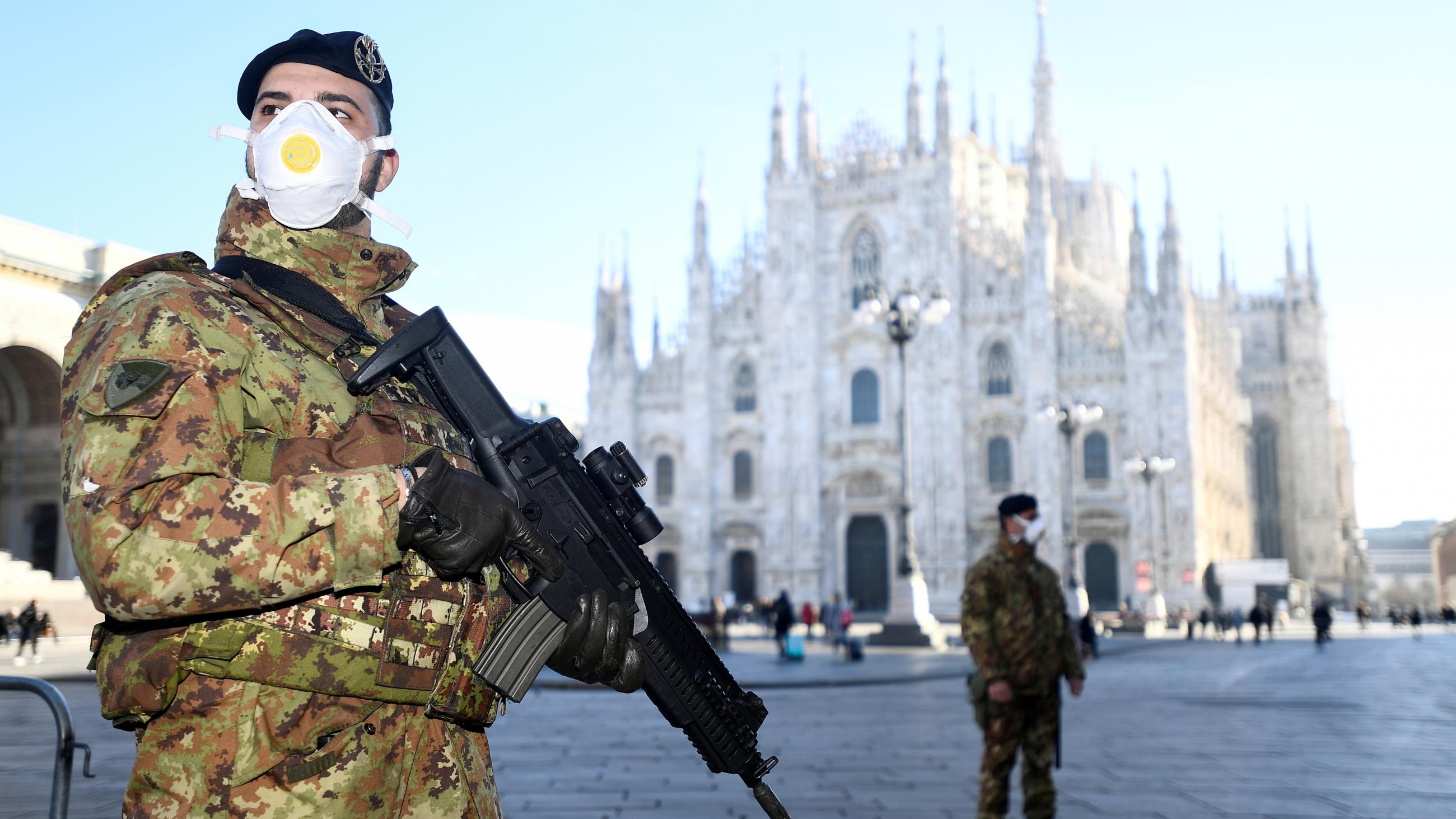 Italian military officers wearing face masks stand outside Duomo cathedral, closed by authorities due to the COVID-19 outbreak.