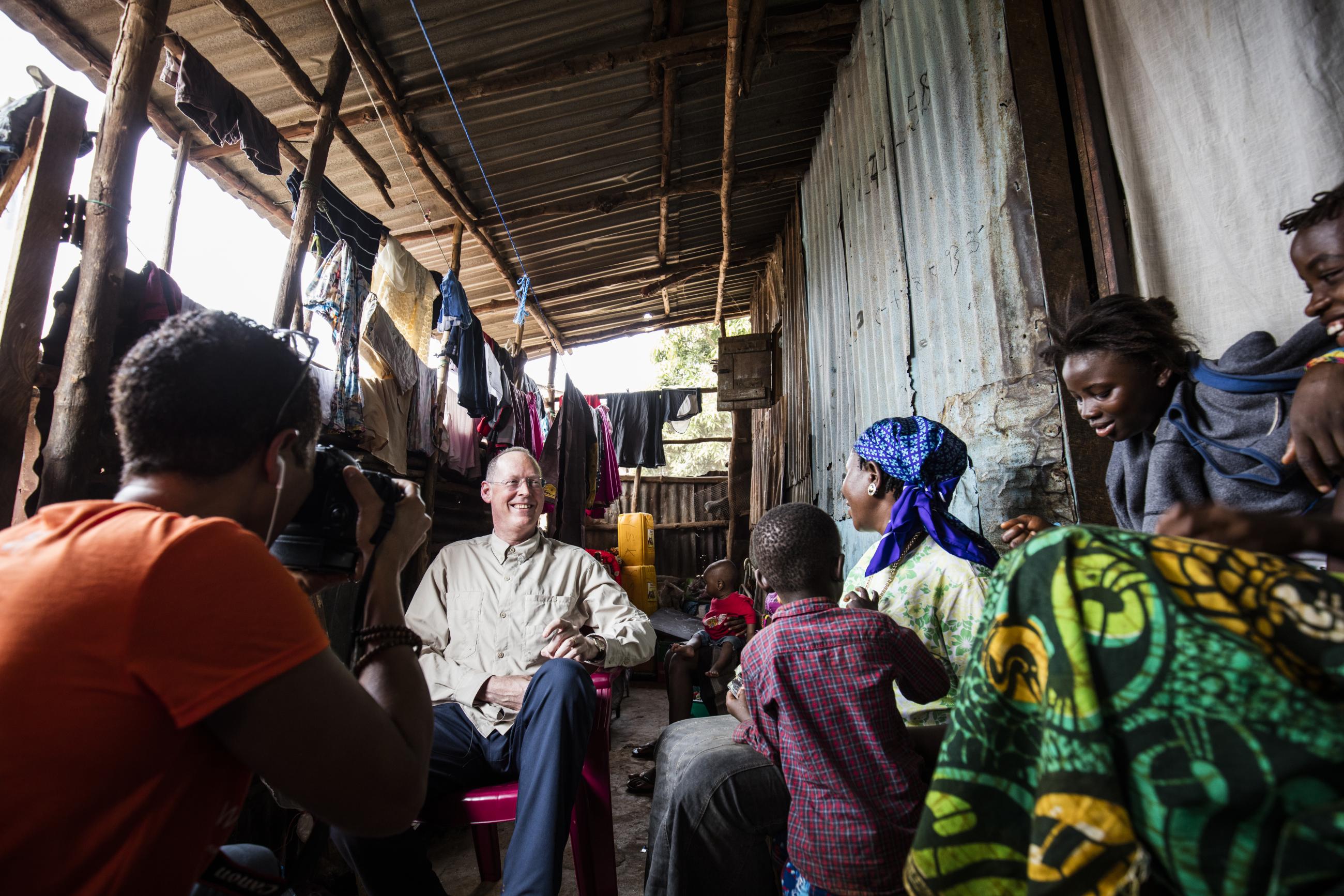 Paul Farmer visits Ebola survivor Yabom Koroma and her family at their home in the Mountain Court section of Freetown, Sierra Leone on December 14, 2015. Photo courtesy of PIH.