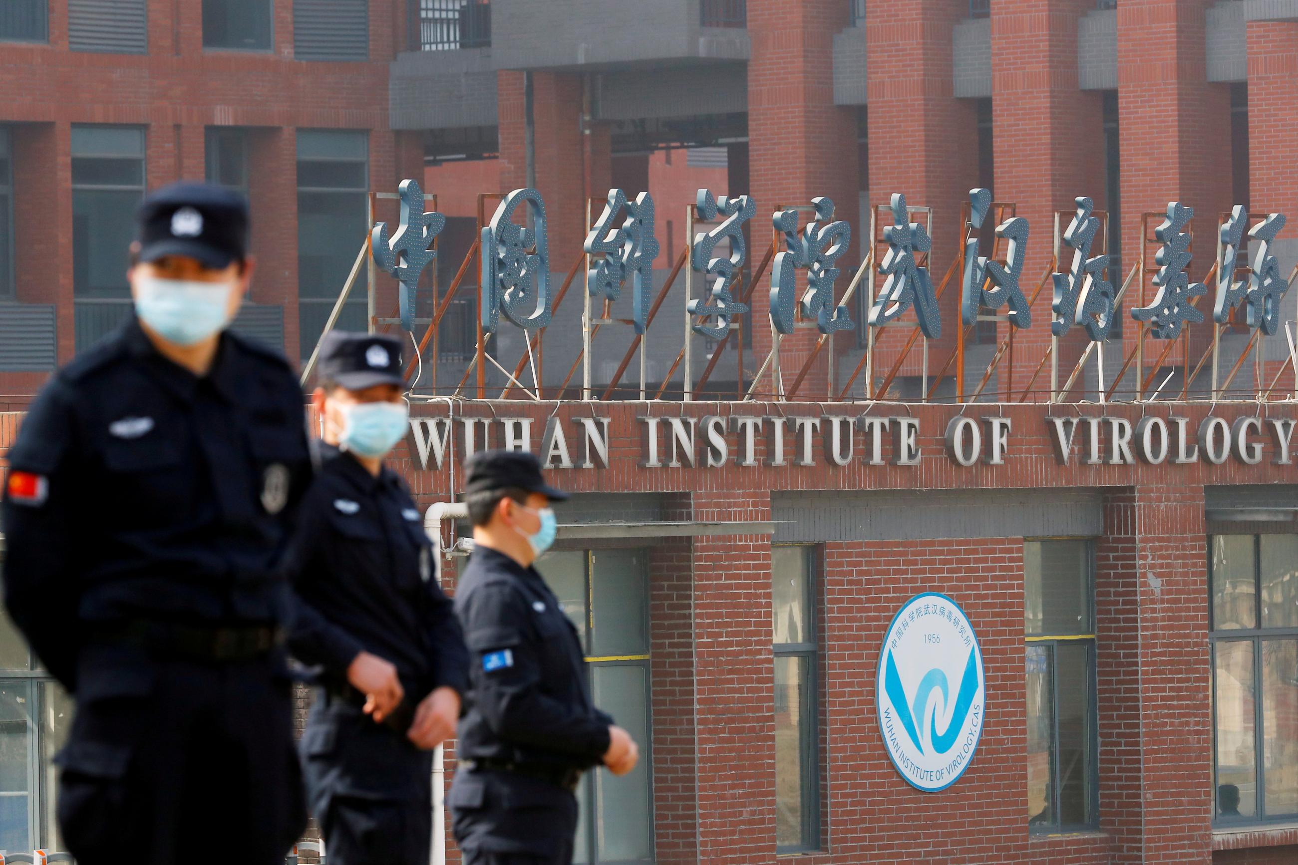 Security personnel keep watch outside the Wuhan Institute of Virology during the visit by the WHO team tasked with investigating the origins of COVID-19 in Wuhan, Hubei province, China on February 3.