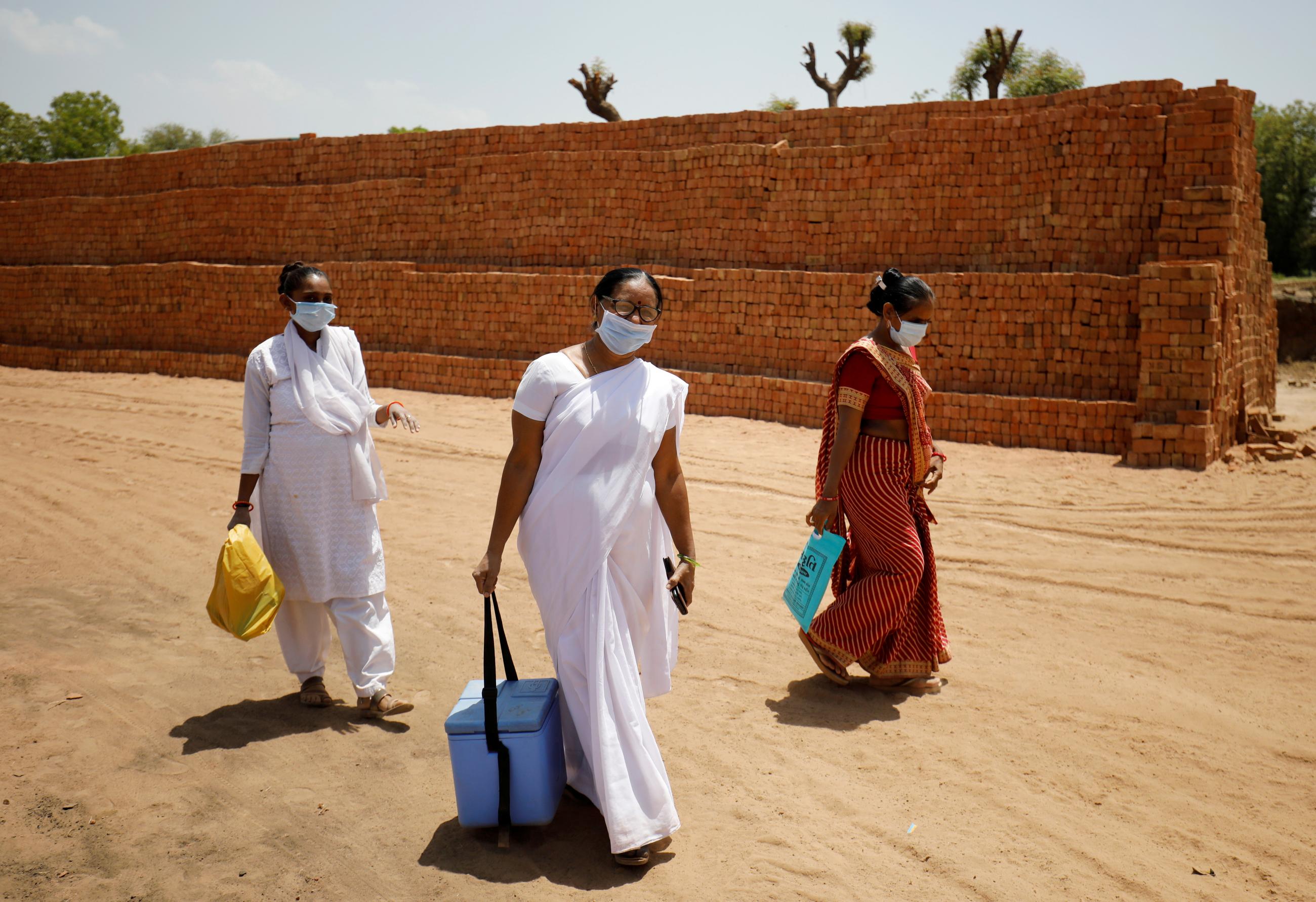 Health-care workers arrive with doses of COVISHIELD, a COVID vaccine manufactured by Serum Institute of India, at Kavitha village on the outskirts of Ahmedabad, India on April 8, 2021. REUTERS/Amit Dave