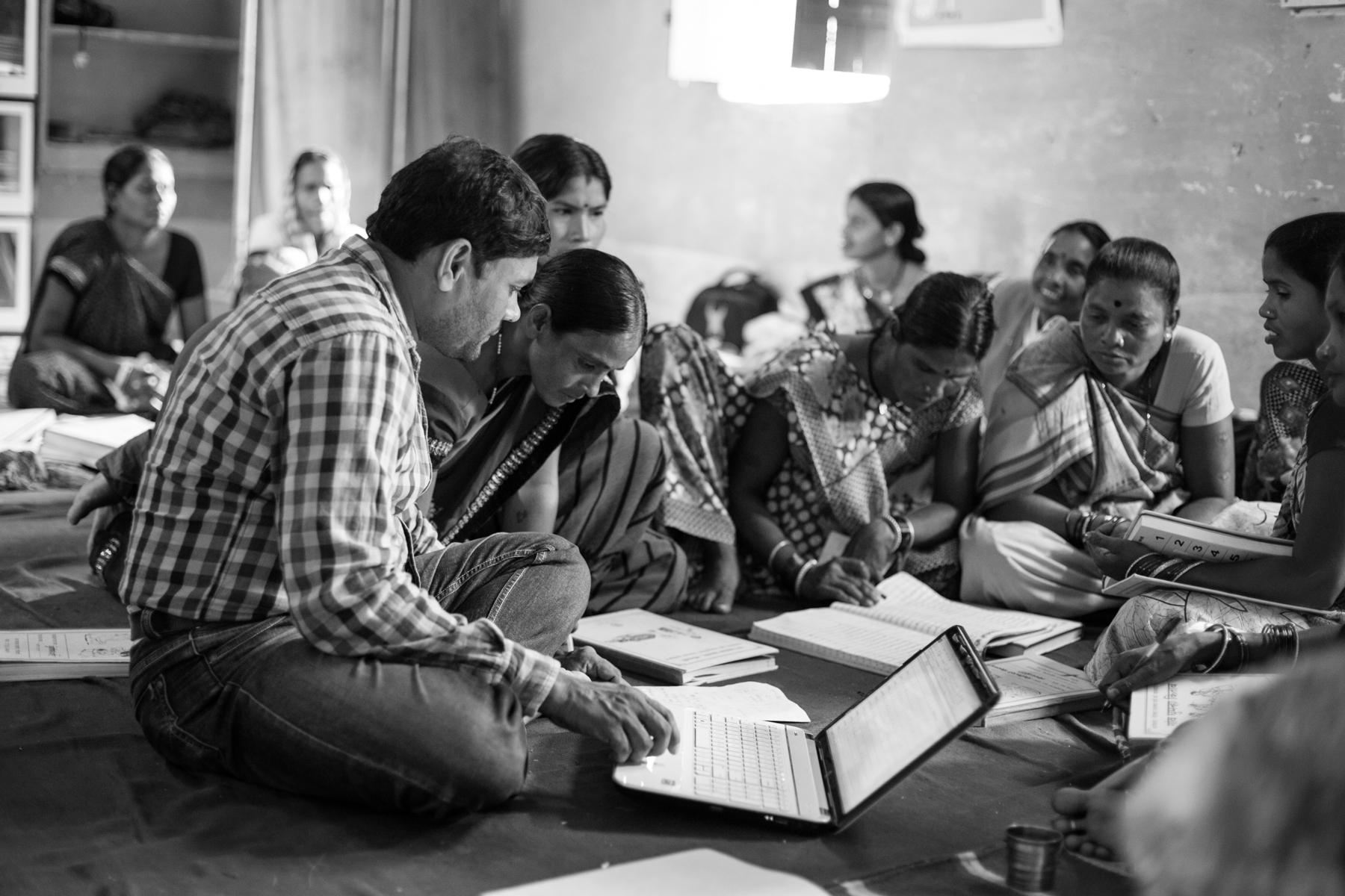 Prafull Chandel, senior field coordinator at Jan Swasthya Sahyog, discusses the data collected by village health workers during their monthly meeting. Regular supportive supervision is key to successful community programs.