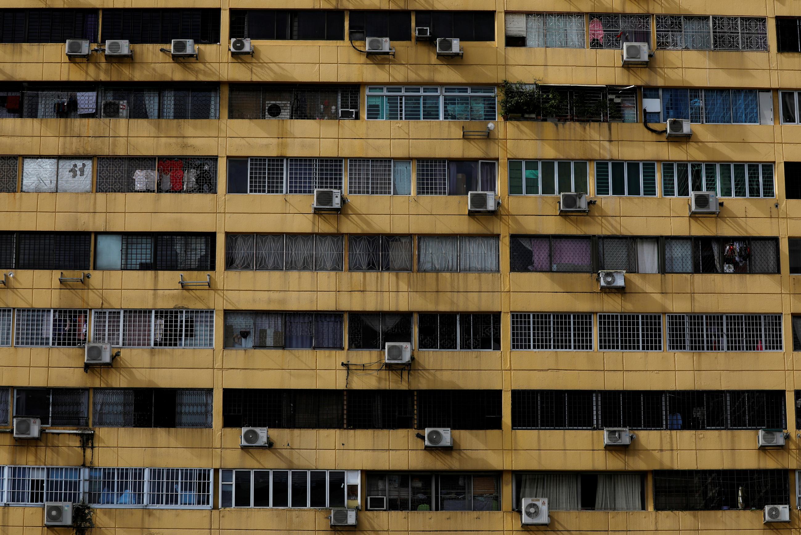 Air-conditioning units dot the facade of People's Park Complex condominium in Singapore, January 5, 2021