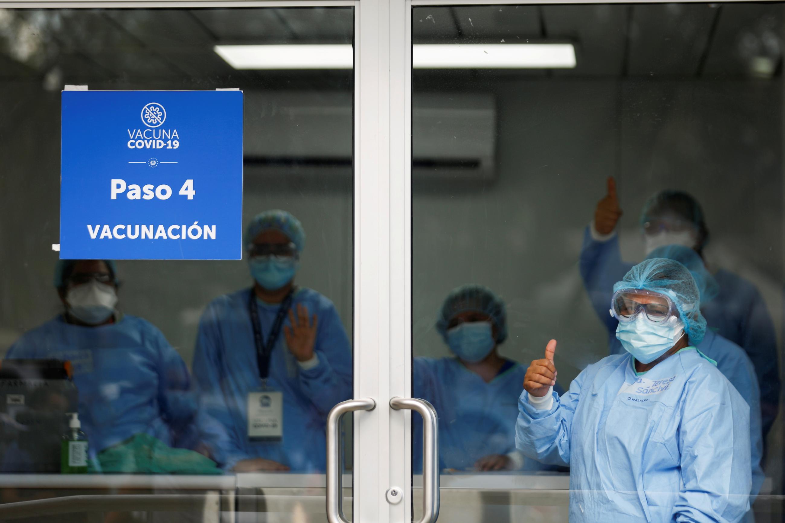 Health workers watch a news conference after administering doses of the AstraZeneca (SKBio Corea) COVID-19 vaccine under the COVAX scheme at a public health center in San Salvador, El Salvador on March 12, 2021.