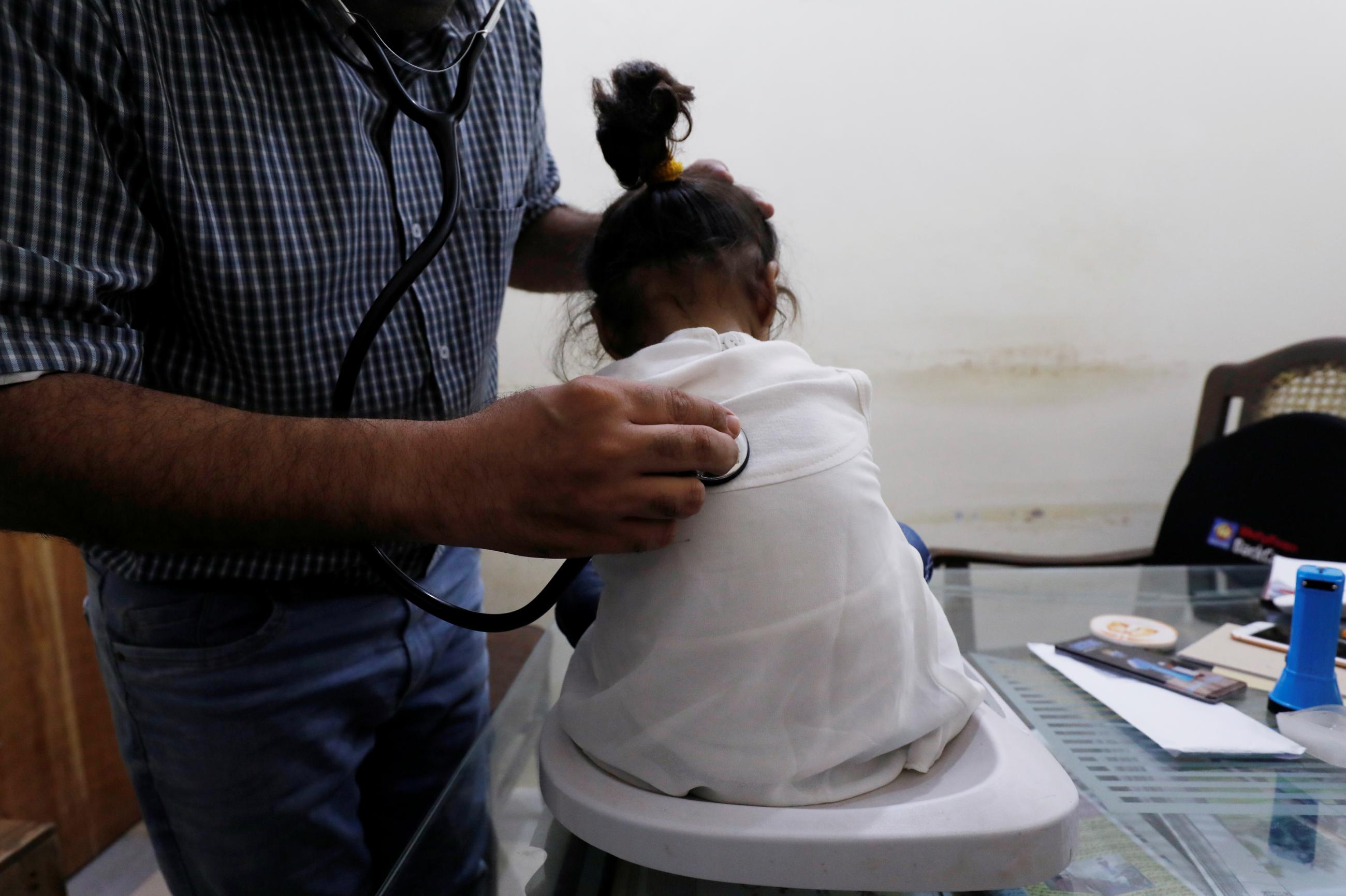 A two-year-old HIV-positive girl, who is under treatment, goes through a routine medical check-up at a clinic in Ratodero, Pakistan, on May 24, 2019.