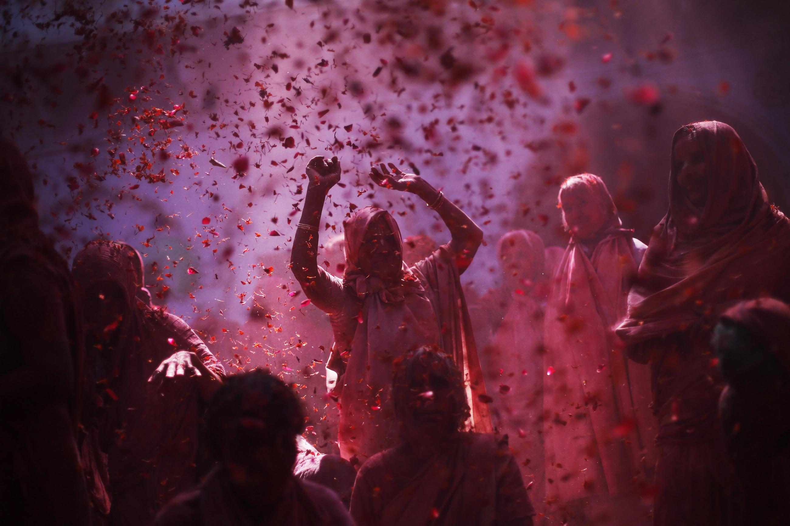 Widows daubed in colours chant religious hymns as they take part in the Holi celebrations organised by non-governmental organisation Sulabh International at a widows' ashram at Vrindavan in the northern Indian state of Uttar Pradesh March 5, 2015