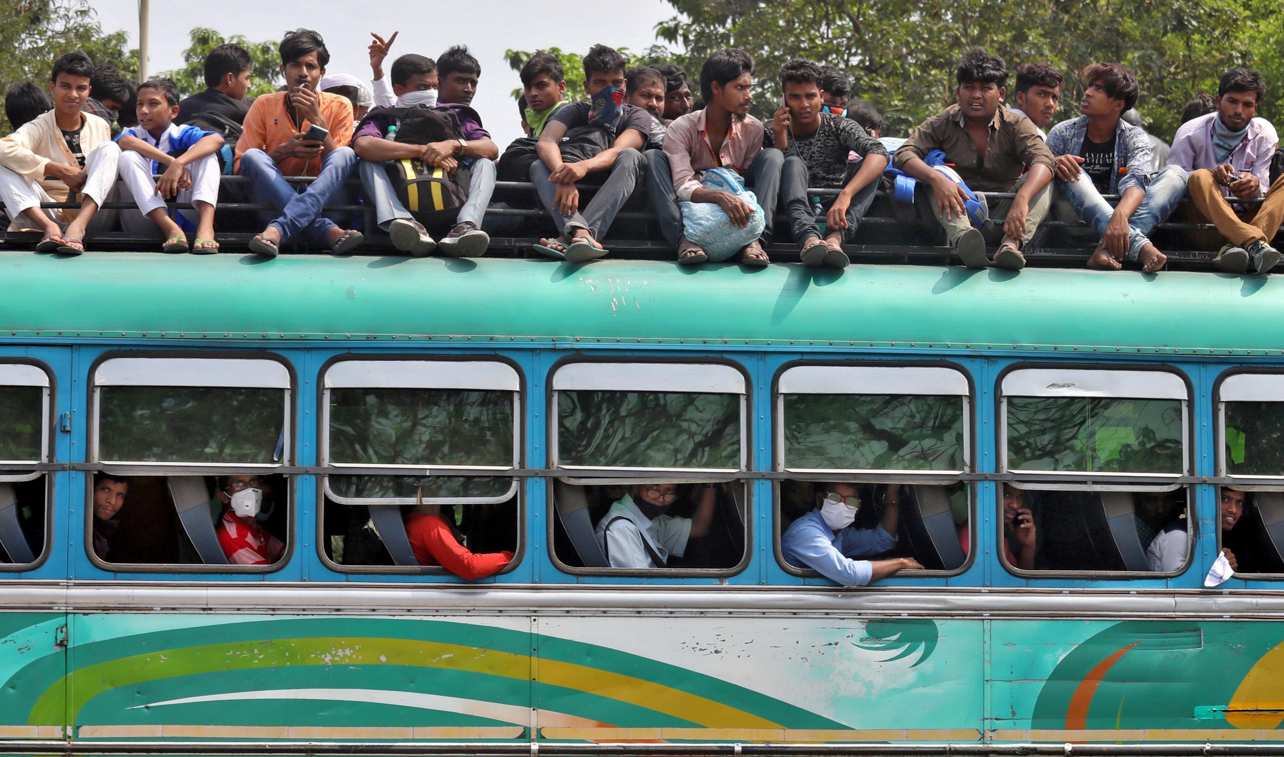 People travel in a crowded bus to return to their cities and villages before the start of the lockdown by West Bengal state government to limit the spreading of coronavirus disease (COVID-19), in Kolkata, India March 23, 2020