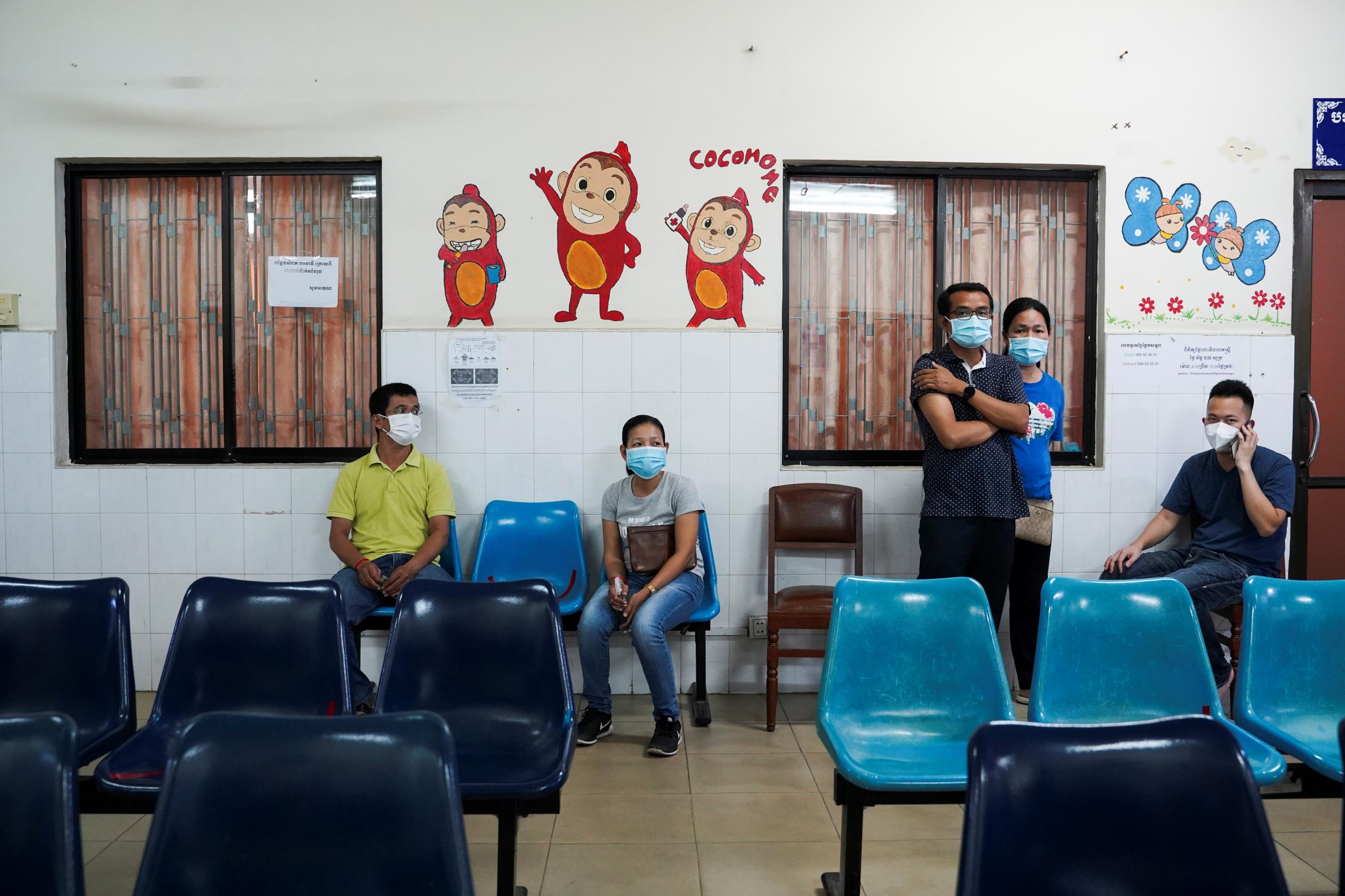 People wait to receive an AstraZeneca coronavirus disease (COVID-19) vaccine as a booster dose at the National Pediatric Hospital in Phnom Penh, Cambodia, August 12, 2021.