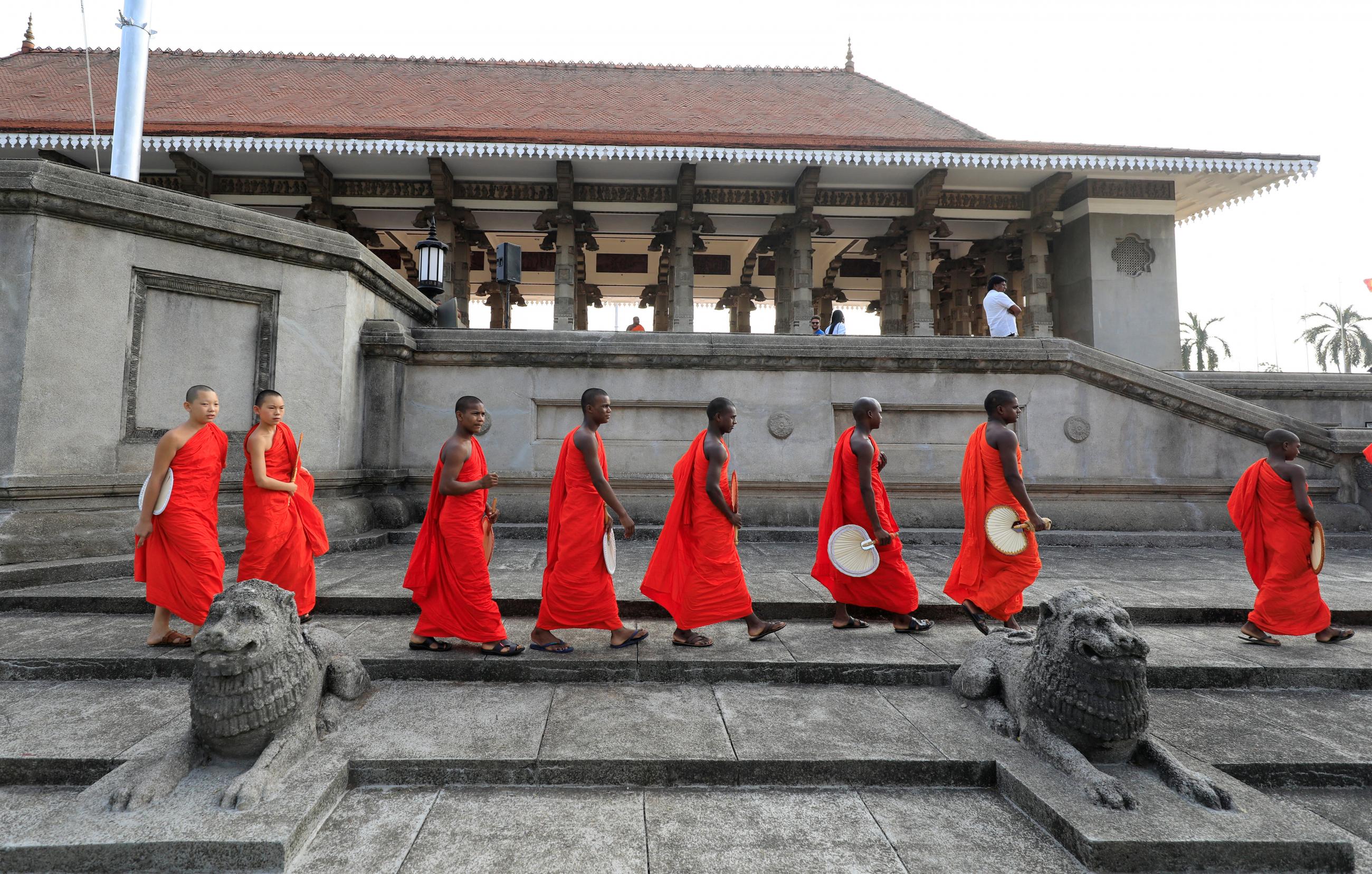 Buddhist monks arrive for the prayers of a pirith chanting through out the night for the well being of coronavirus affected people in the world