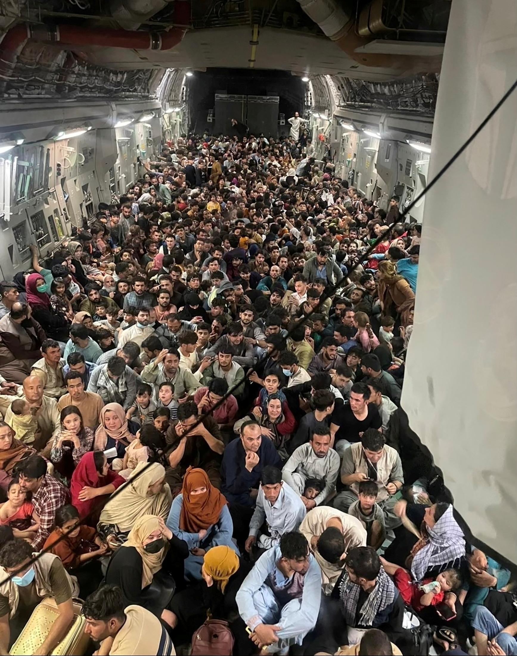 Evacuees crowd the interior of a U.S. Air Force C-17 Globemaster III transport aircraft, carrying some 640 Afghans to Qatar from Kabul, Afghanistan on August 15, 2021.