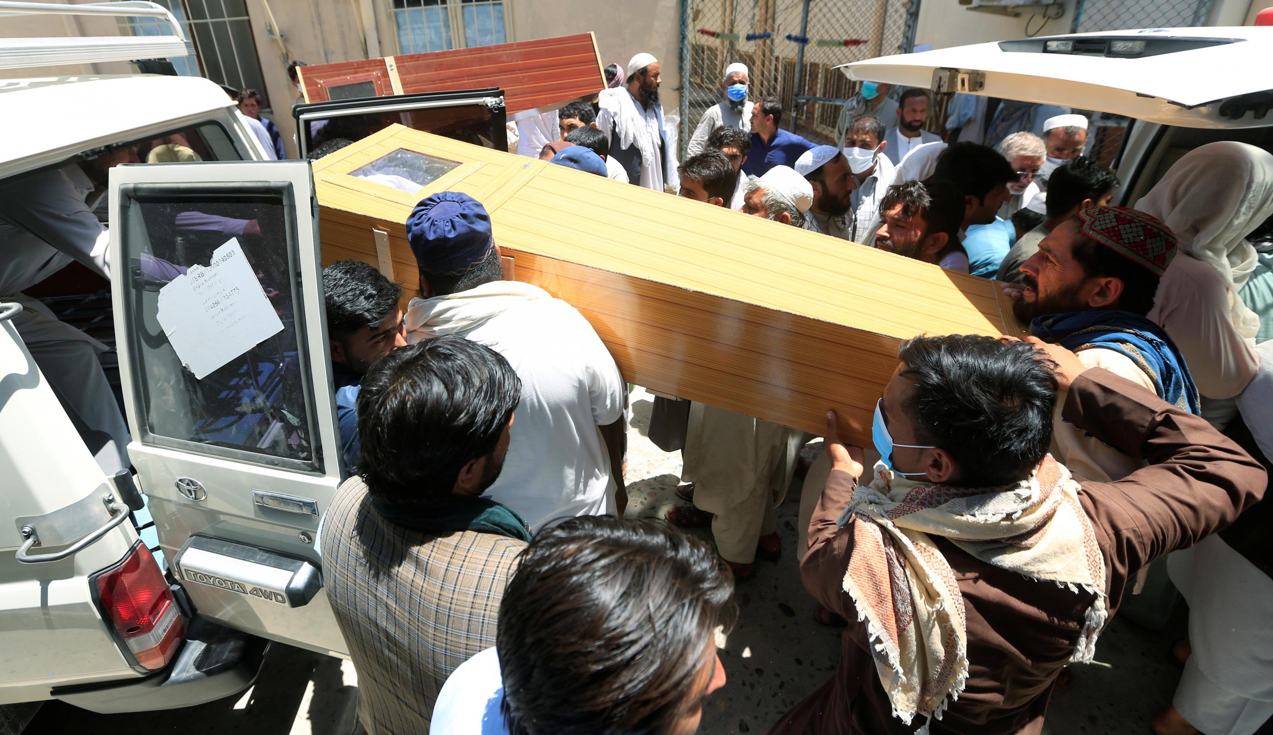 Afghan men carry the coffin of a polio vaccination health worker who was shot and killed by unknown gunmen. Photo taken in Jalalabad, Afghanistan, on June 15, 2021.