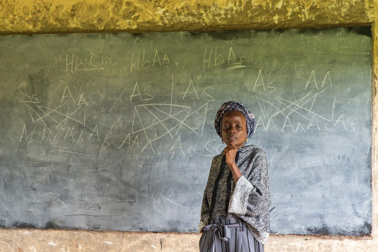 Lea Masamo stands in front of blackboard
