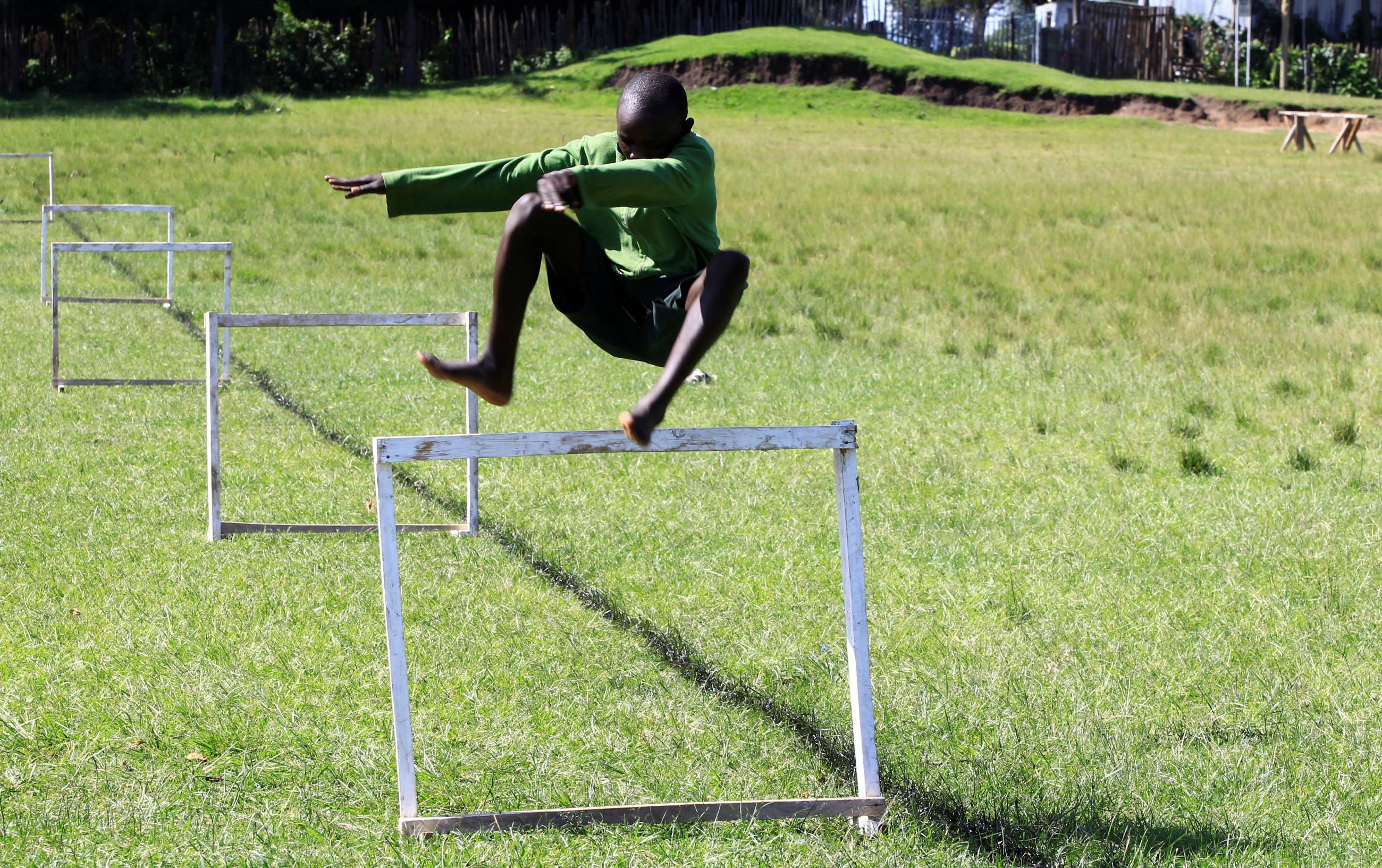 A student at Kamoi Primary School jumps a hurdle during a steeplechase exercise session at his school’s field in Elgeyo-Marakwet County, Kenya, on August 6, 2021.