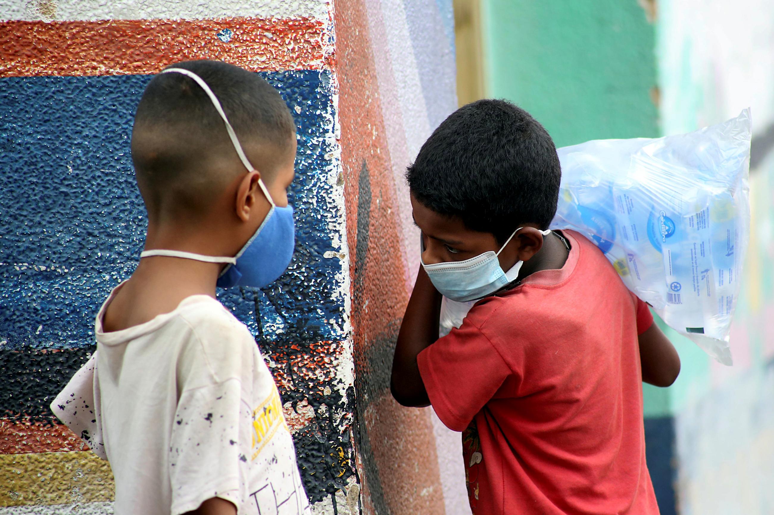 Children in face masks near the Venezuelan-Colombia border after the Colombian government closed the Simón Bolívar International Bridge as a preventive measure in response to COVID spreading in San Antonio, Tachira, Venezuela. Photo taken on March 14, 2020.