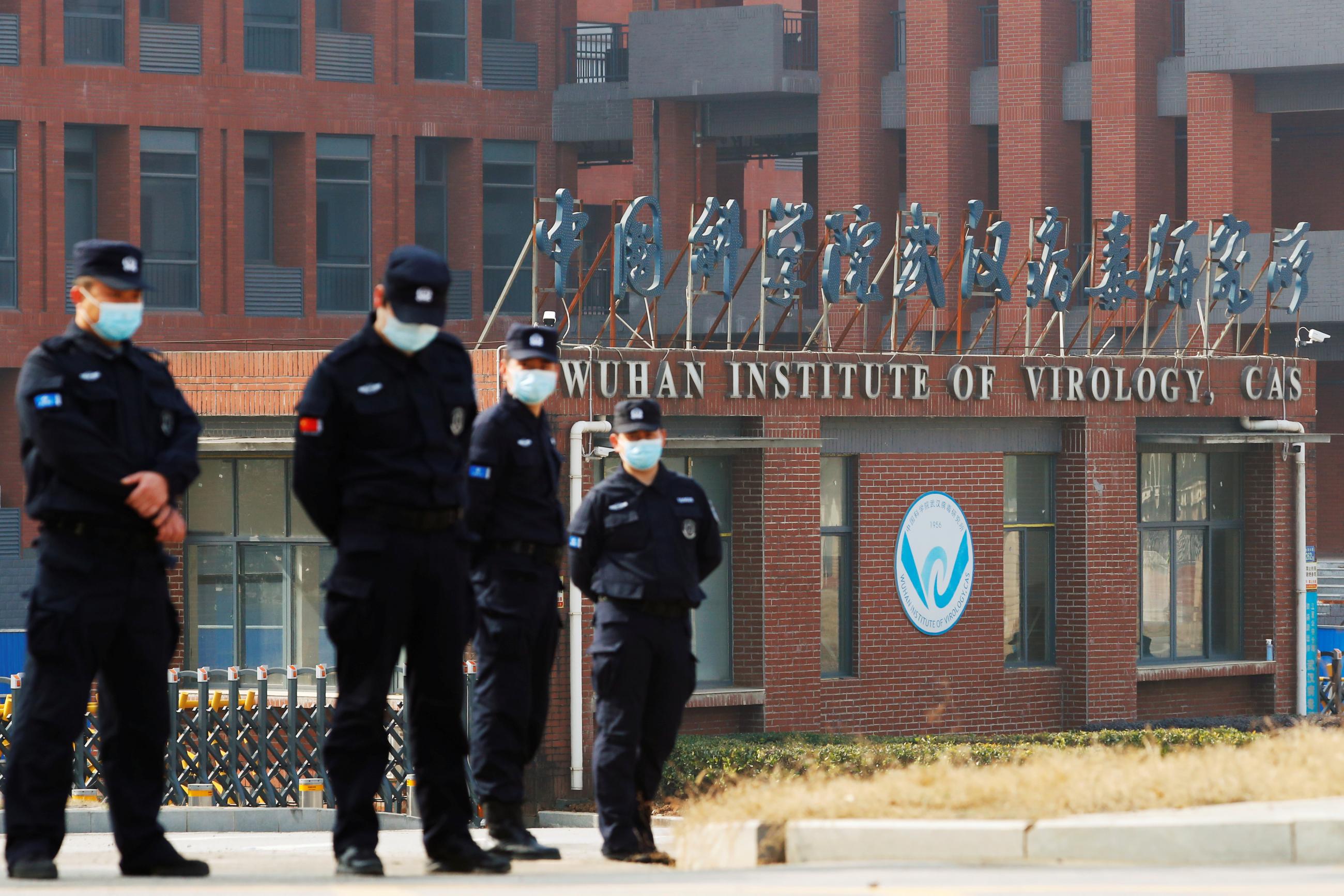 Security personnel keep watch outside Wuhan Institute of Virology during the visit by the World Health Organization (WHO) team tasked with investigating the origins of the coronavirus disease (COVID-19), in Wuhan, Hubei province, China February 3, 2021.