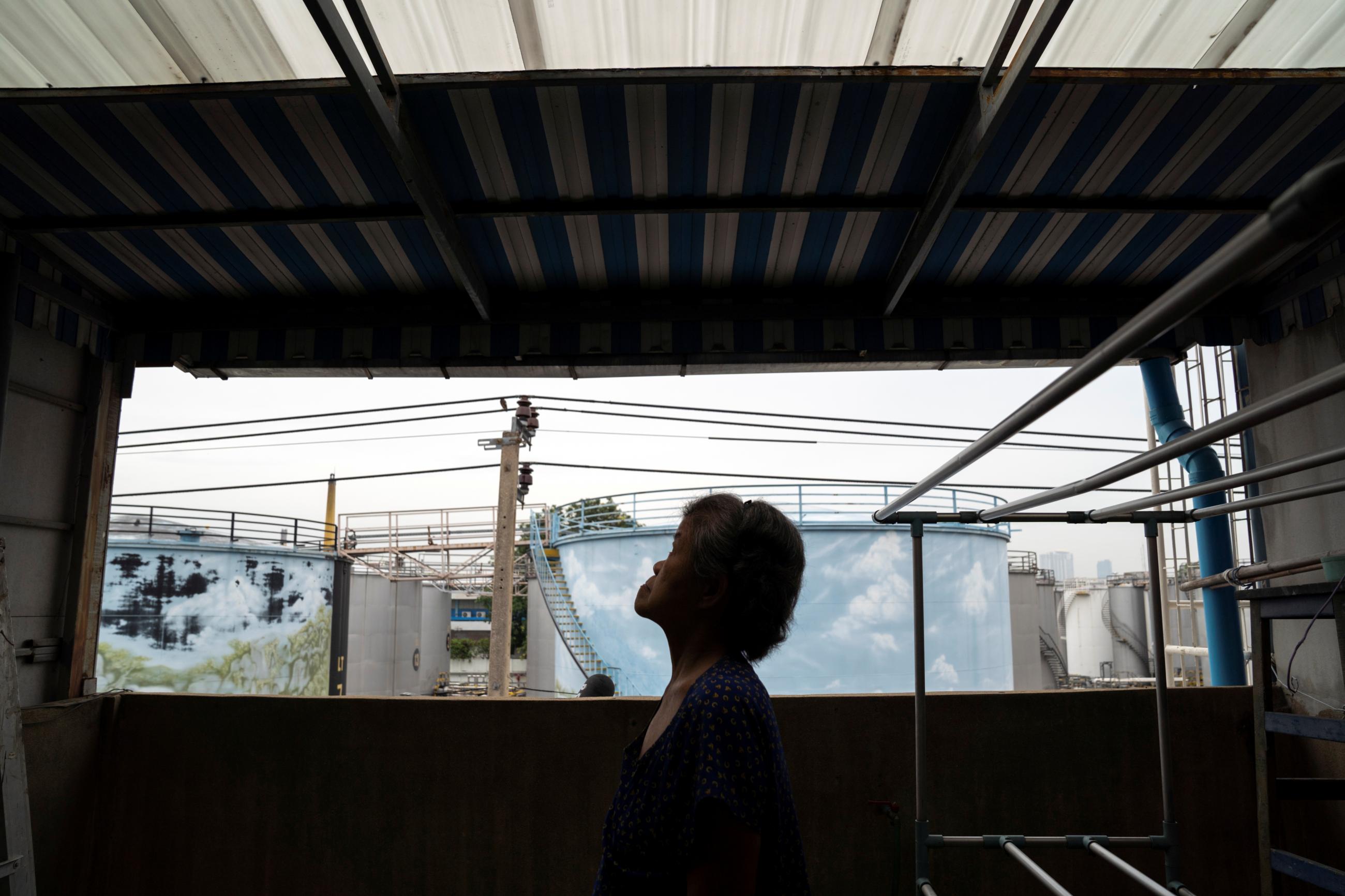 Praphai Yodpradit, looks up where she found her niece Nitiwadee Sae-Tia's body after she took her own life at home, during the COVID-19 outbreak, in Bangkok, Thailand, on May 26, 2020.