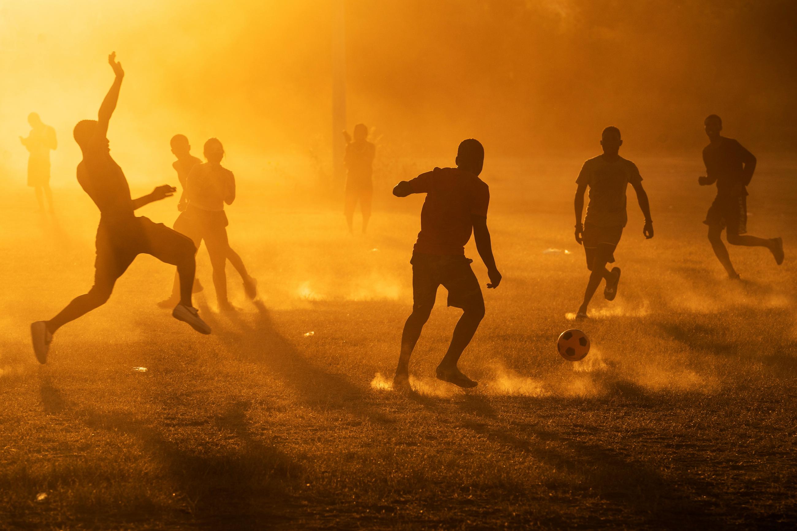 Migrants seeking asylum in the U.S., who returned to the Mexican side of the border to avoid deportation, play soccer in a makeshift migrant camp in Braulio Fernandez Ecological Park in Ciudad Acuna, Mexico, September 22, 2021.