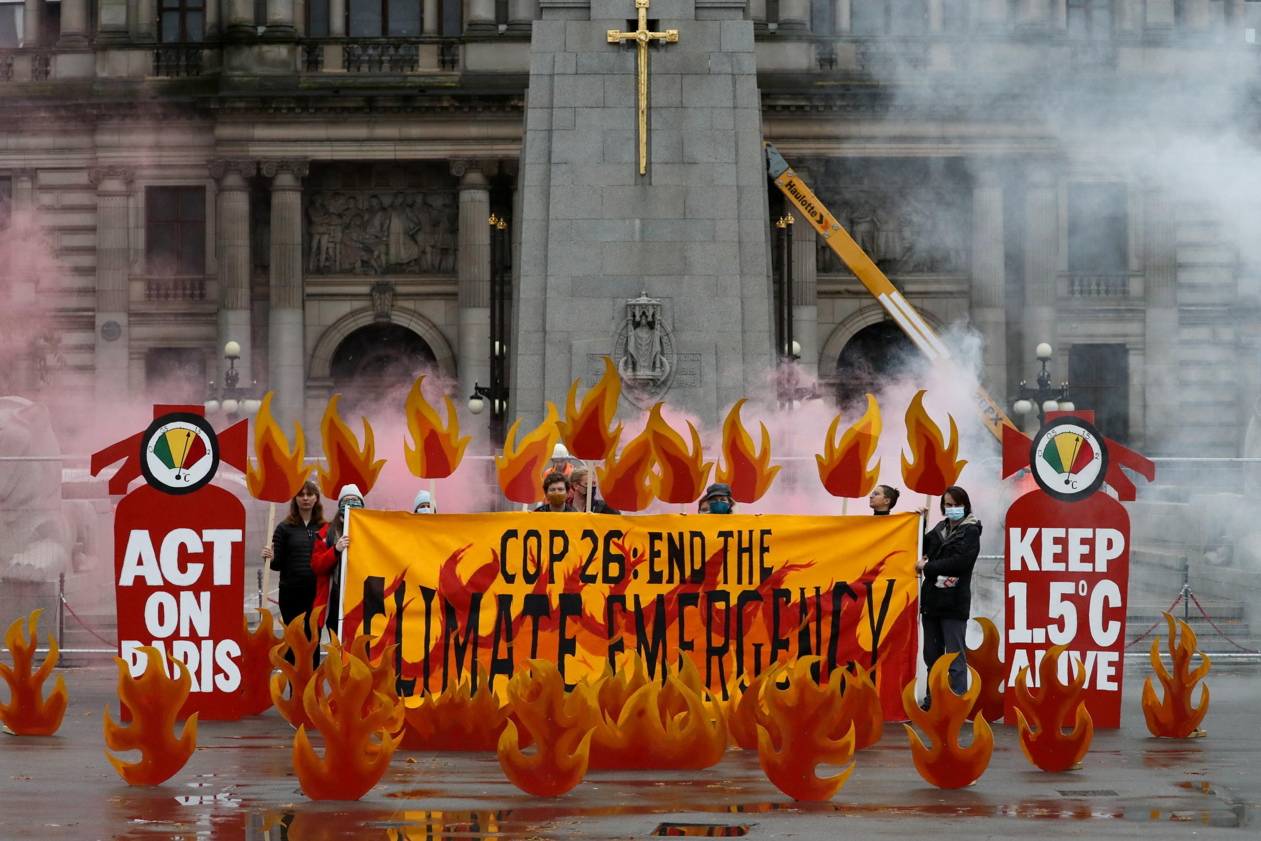 Activists symbolically set George Square on fire with an art installation of faux flames and smoke ahead of the UN Climate Change Conference (COP26), in Glasgow, Scotland, Britain October 28, 2021.