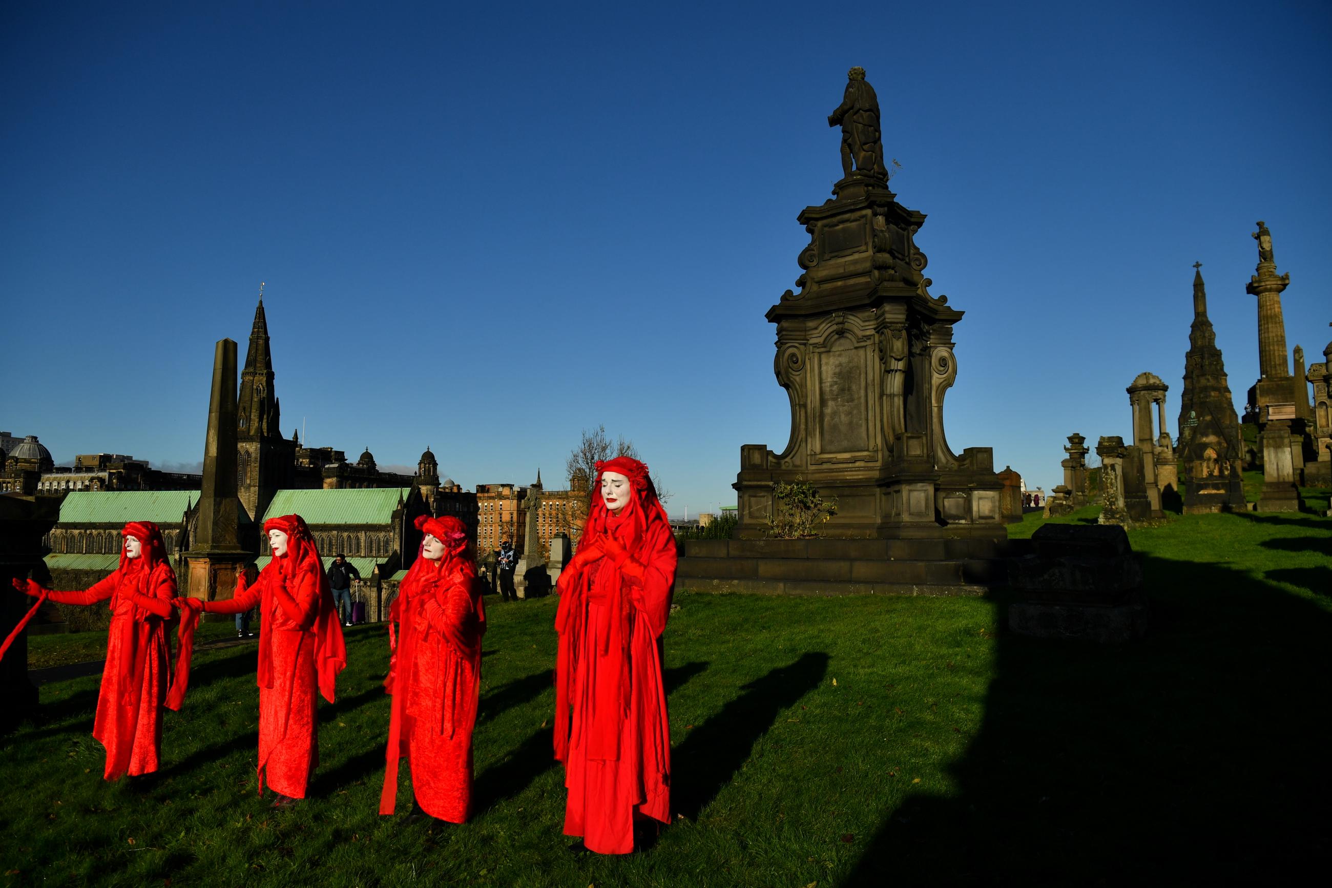 Activists take part in a mock funeral at Glasgow Necropolis during COP26 in Glasgow, Scotland, on November 13, 2021.