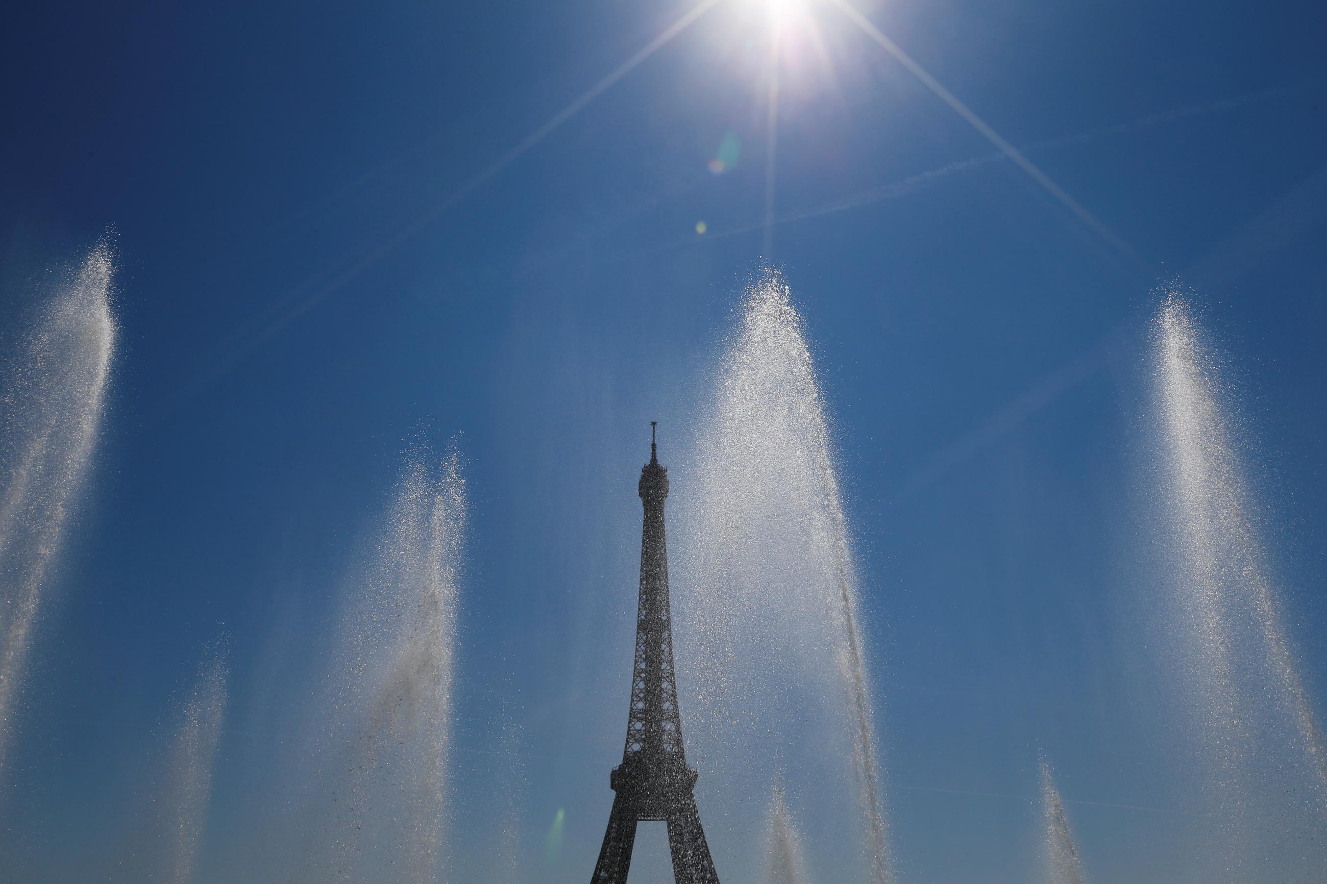 Fountains frame the Eiffel Tower during a summer heatwave in Paris, France, on August 3, 2018. 