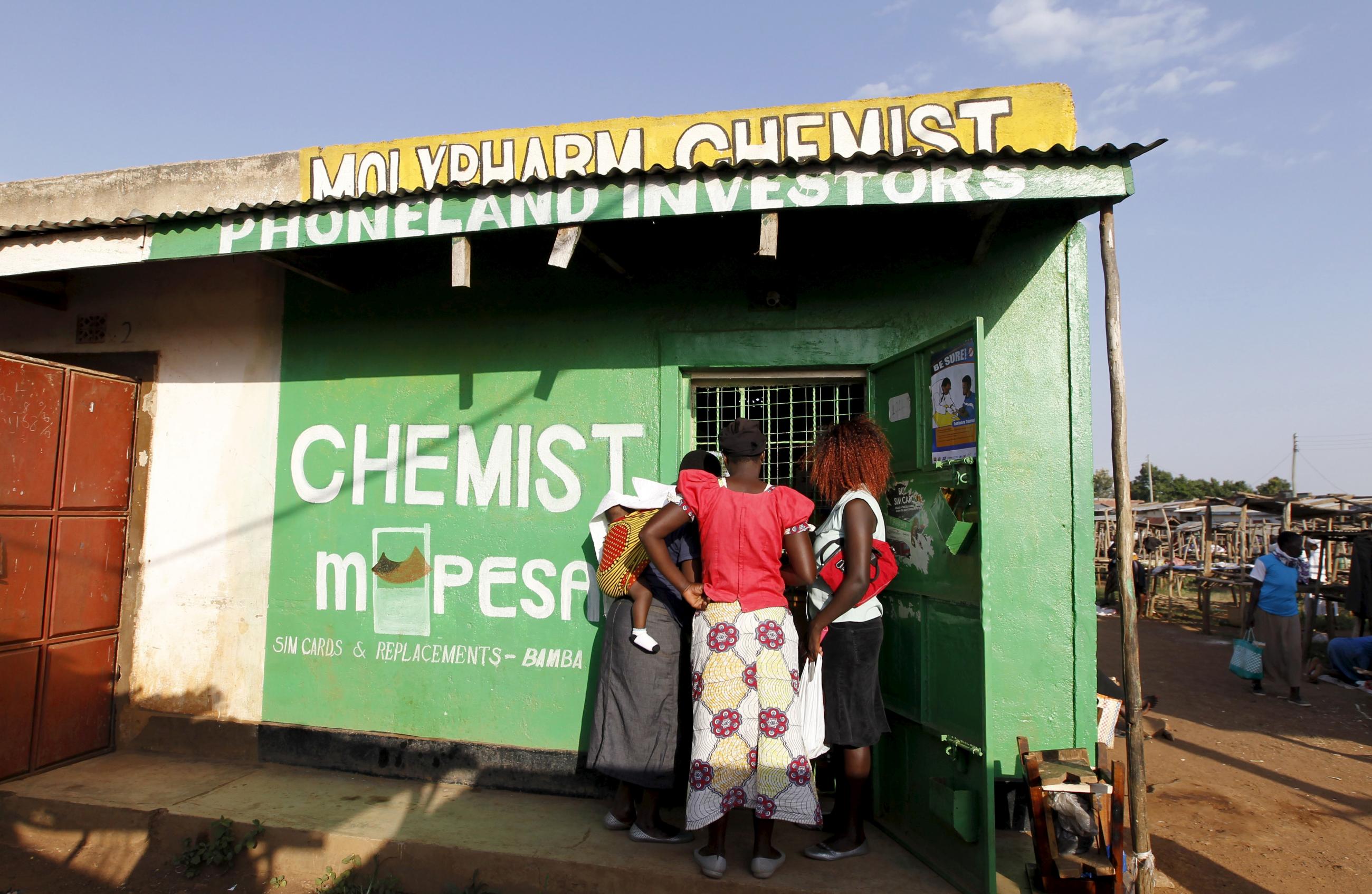 Customers wait to be served at a chemist in the village of Kogelo, west of Kenya's capital Nairobi, July 15, 2015.