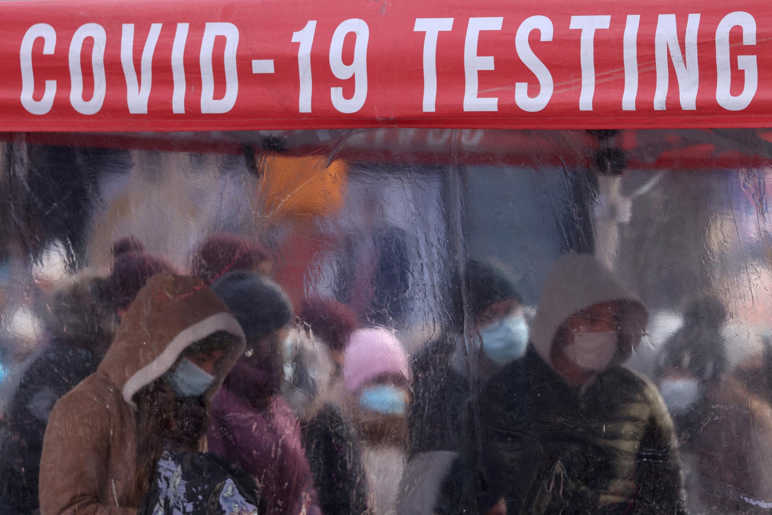 People queue to be tested for COVID-19 in Times Square, as the omicron variant continues to spread in New York City, on December 20, 2021.