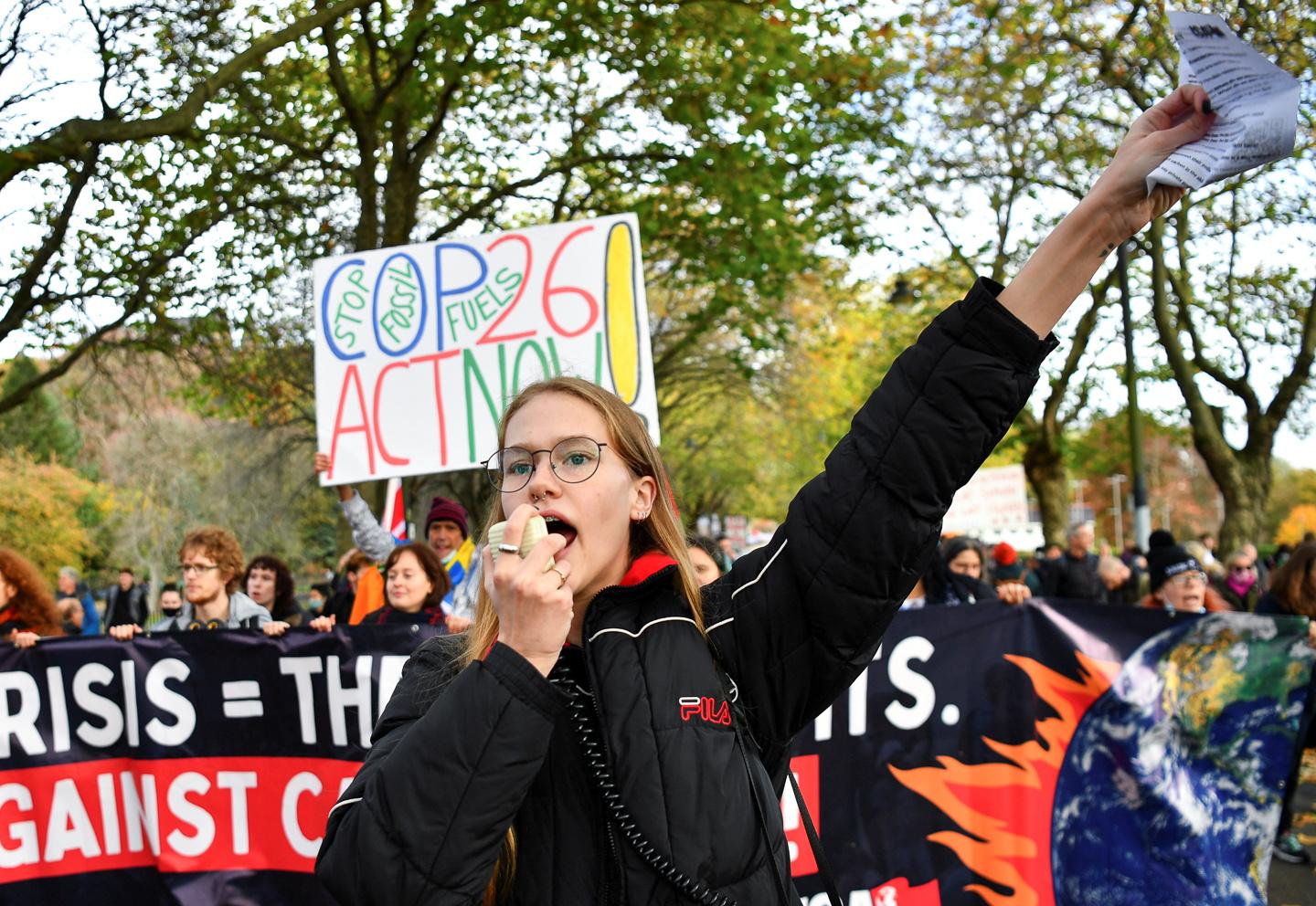 A demonstrator speaks through a megaphone as Youth activists protest in the Fridays for Future march during the UN Climate Change Conference (COP26), in Glasgow, Scotland, Britain, November 5, 2021.
