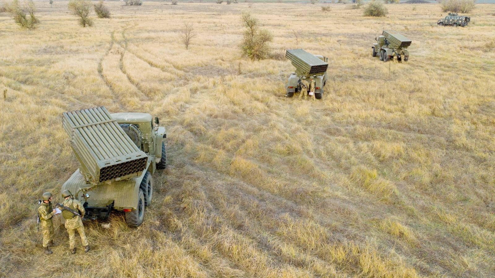 Service members of the Ukrainian Armed Forces gather near vehicles, including BM-21 "Grad" multiple rocket launchers, during tactical military exercises at a shooting range in the Kherson region, Ukraine, January 19, 2022.