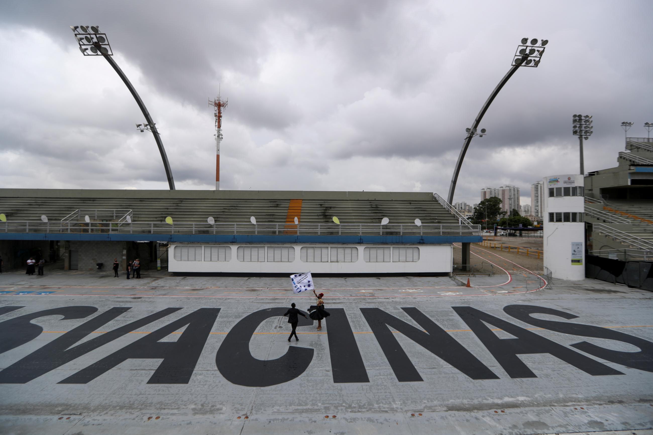 Vai-Vai samba school dancers dance on the word “Vacinas" at São Paulo’s Anhembi Sambadrome where Carnival celebrations were cancelled due to COVID-19, in Brazil, on February 13, 2021.