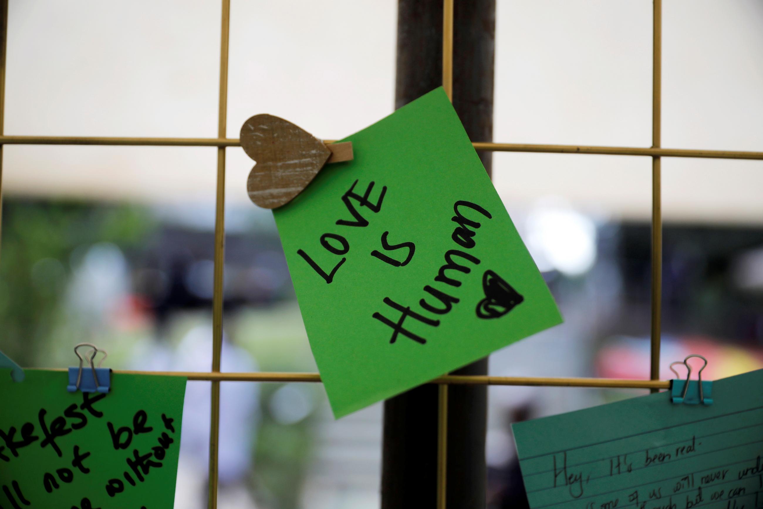A tribute note on green paper to Kenyan author and LGBTQI+ activist Binyavanga Wainaina says says "Love is Human." Wainaina died in Nairobi in May 2019, at a memorial service at the Nairobi National Museum.