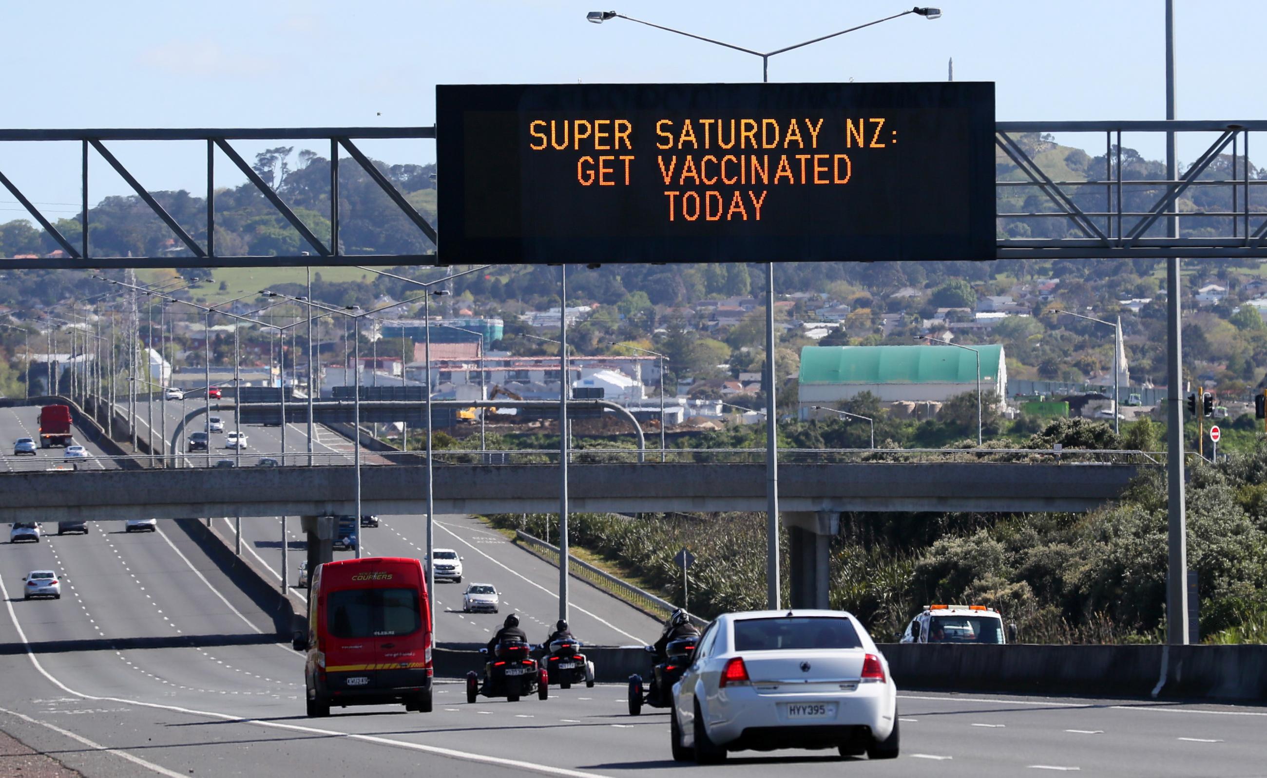 A sign on an Auckland motorway urges people to get vaccinated at a coronavirus disease (COVID-19) vaccination clinic during a single-day vaccination drive, aimed at significantly increasing the percentage of vaccinated people in the country, in Auckland, New Zealand, October 16, 2021