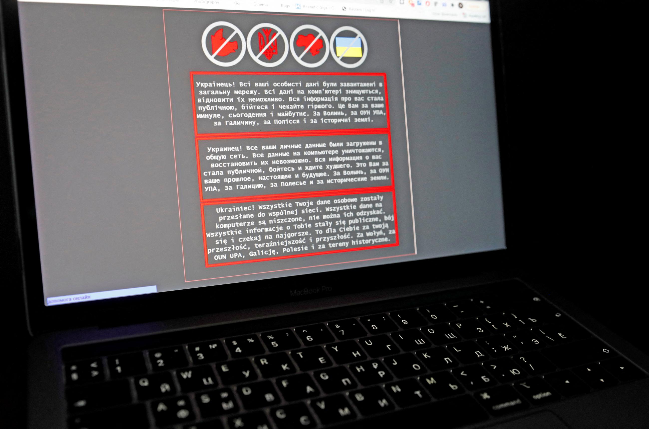 A laptop screen displays a warning message in Ukrainian, Russian and Polish, that appeared on the official website of the Ukrainian Foreign Ministry after a massive cyberattack, in this illustration taken January 14, 2022.