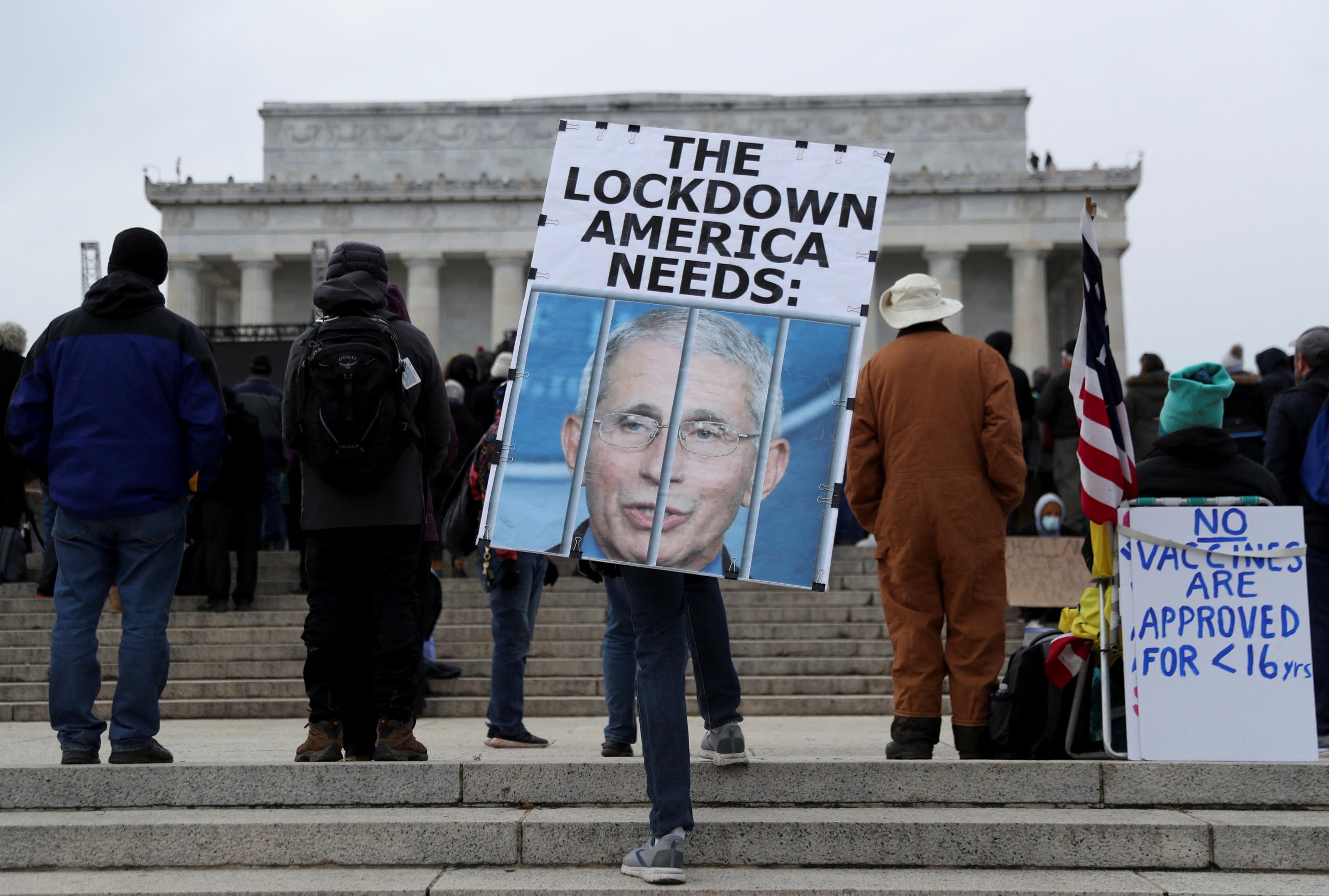 A person holds a placard outside the Lincoln Memorial during a march in opposition to coronavirus disease (COVID-19) mandates on the National Mall in Washington, D.C., U.S., January 23, 2022.